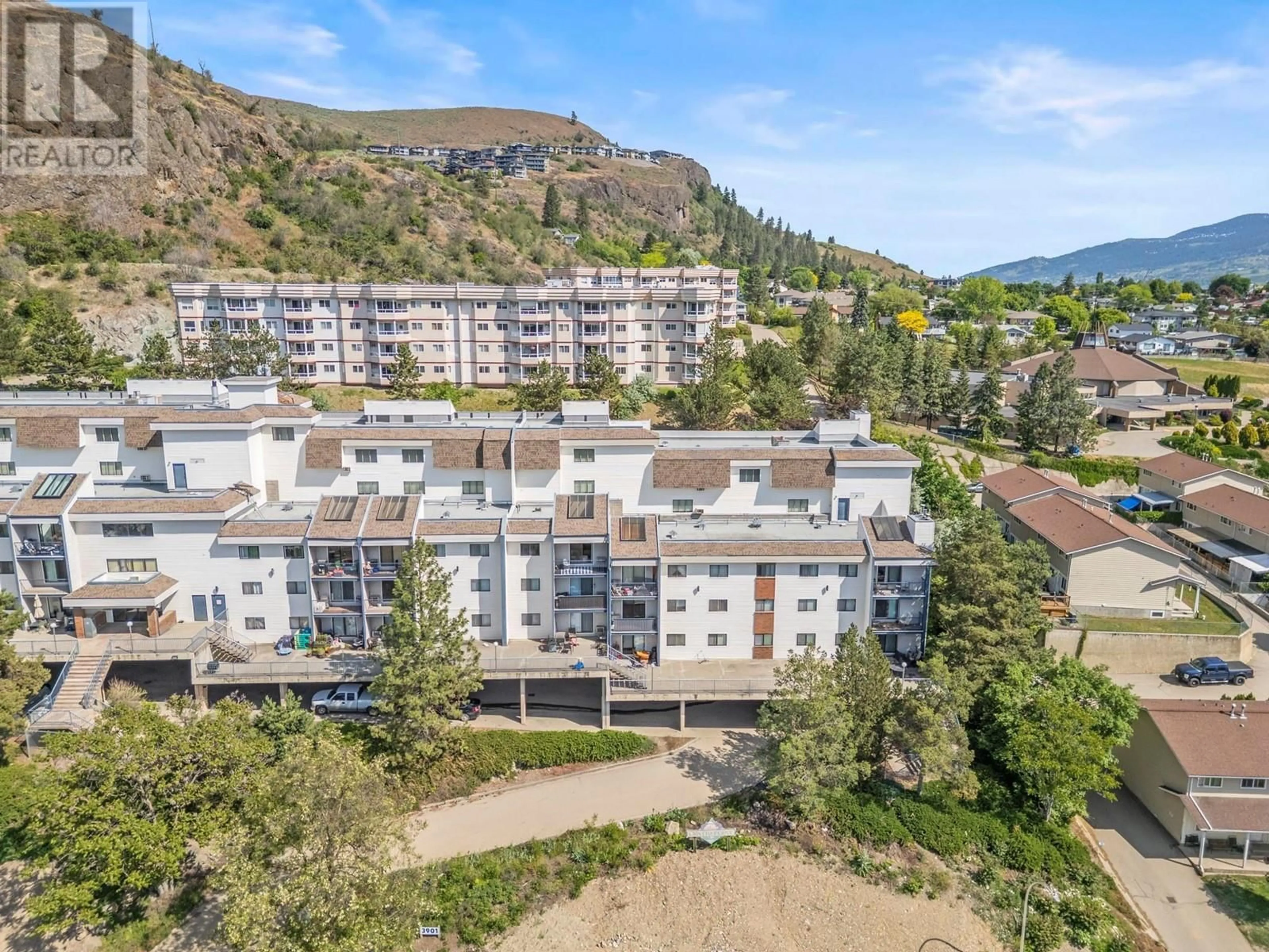 A pic from outside/outdoor area/front of a property/back of a property/a pic from drone, mountain view for 303 - 3901 32 AVENUE, Vernon British Columbia V1T8M3