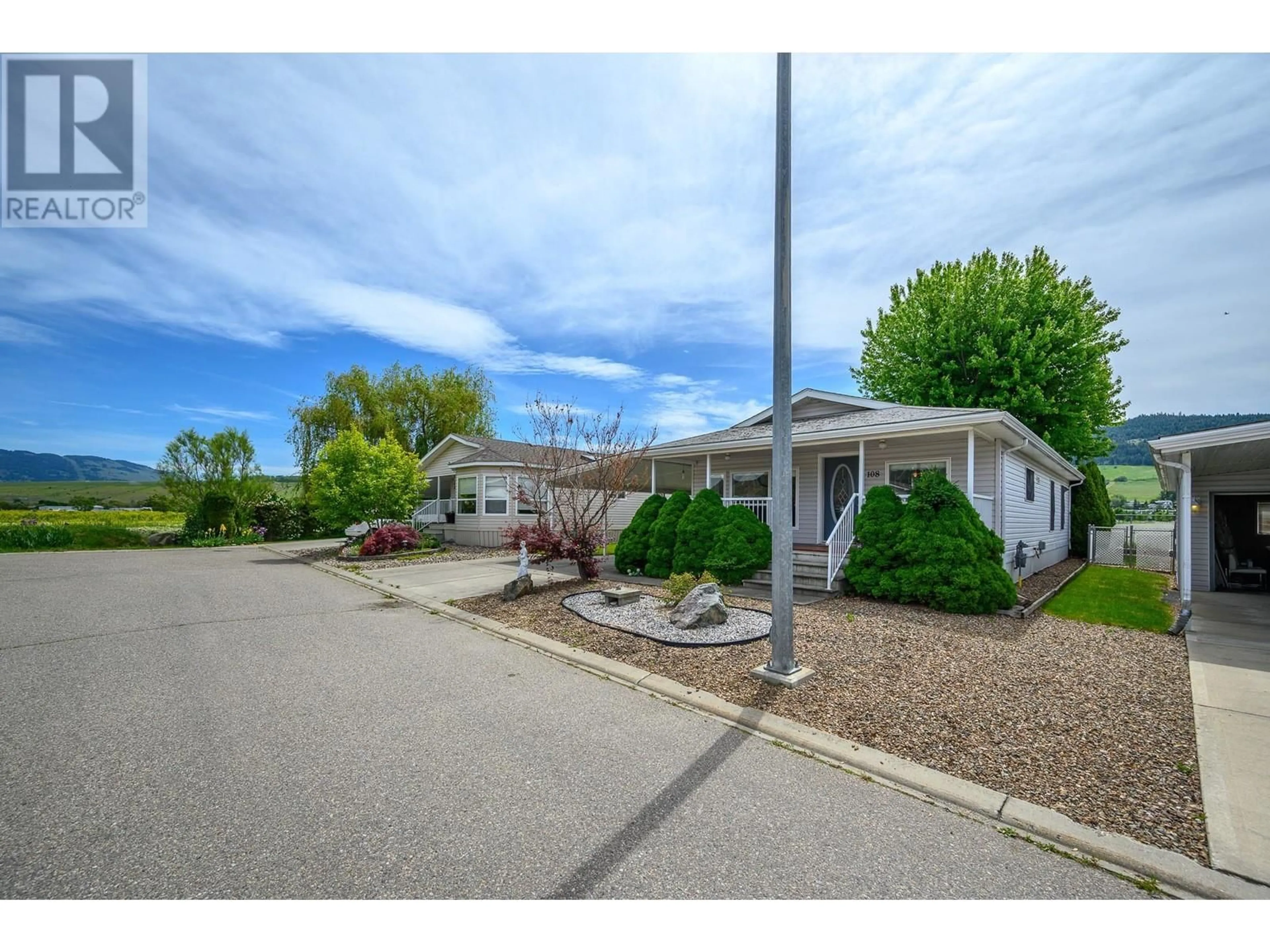 A pic from outside/outdoor area/front of a property/back of a property/a pic from drone, street for 108 - 6688 TRONSON ROAD, Vernon British Columbia V1H1R9
