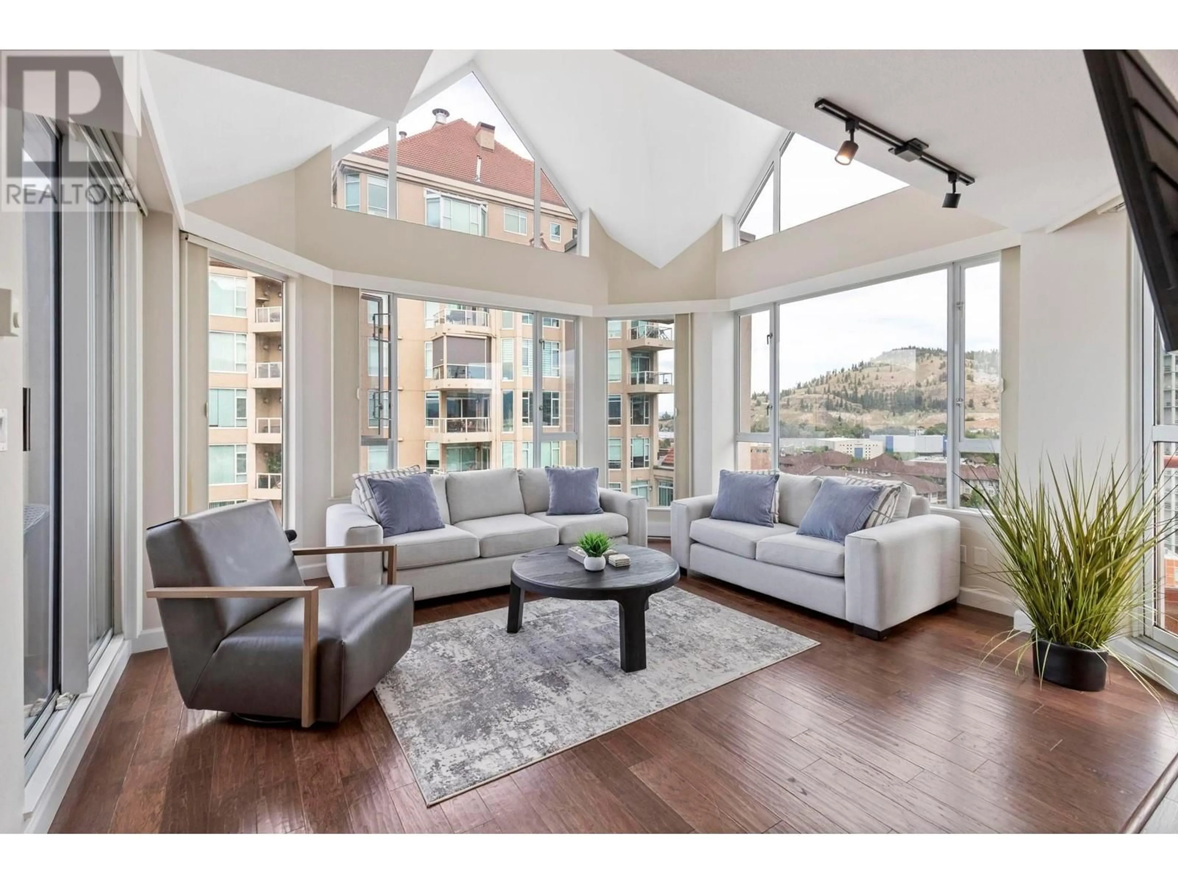 Living room with furniture, wood/laminate floor for 1204 - 1160 SUNSET DRIVE, Kelowna British Columbia V1Y9P7
