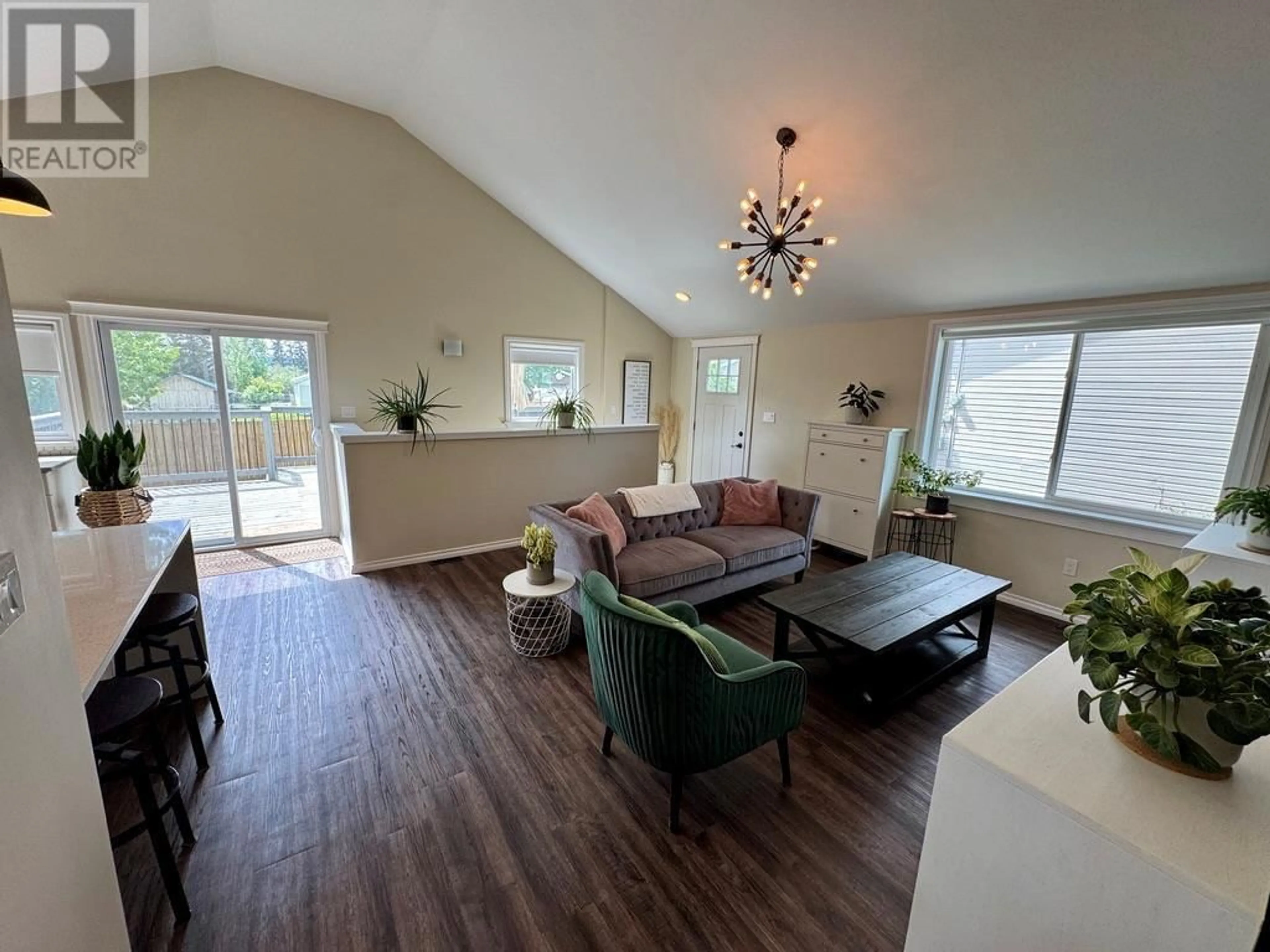 Living room with furniture, wood/laminate floor for 305 98 AVENUE, Dawson Creek British Columbia V1G1R8