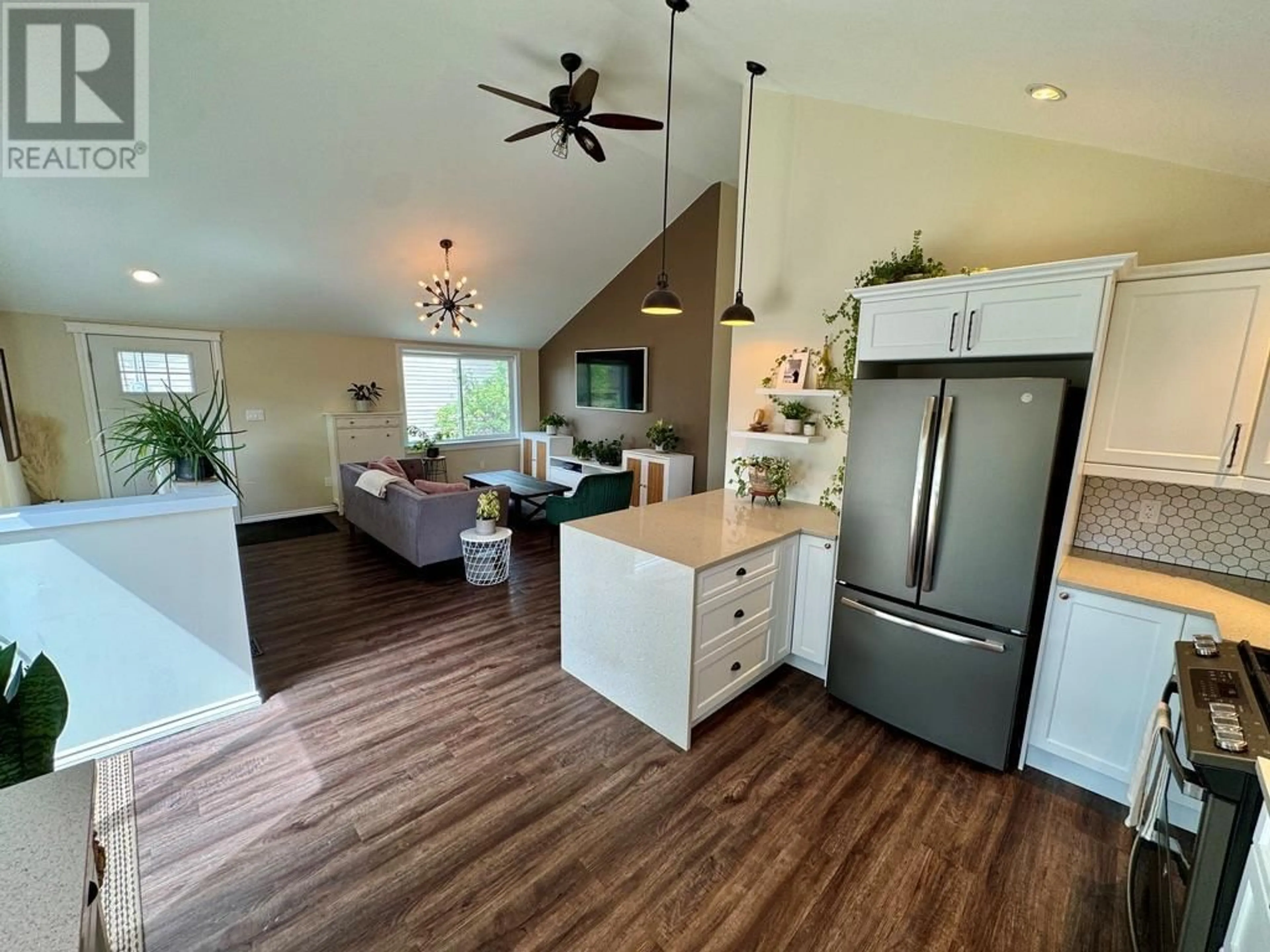 Open concept kitchen, wood/laminate floor for 305 98 AVENUE, Dawson Creek British Columbia V1G1R8