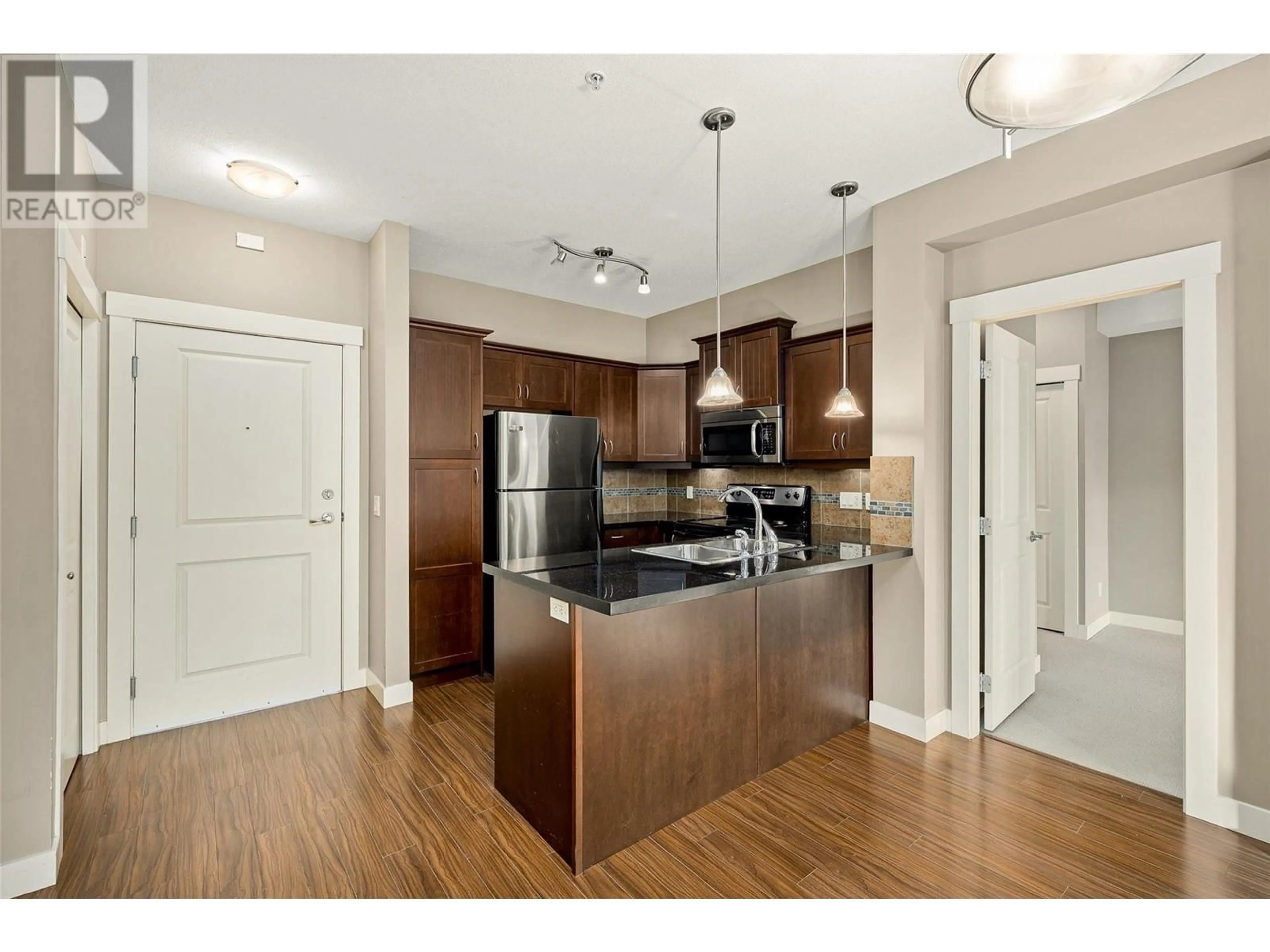Open concept kitchen, wood/laminate floor for 114 - 3521 CARRINGTON ROAD, West Kelowna British Columbia V4T2Z9