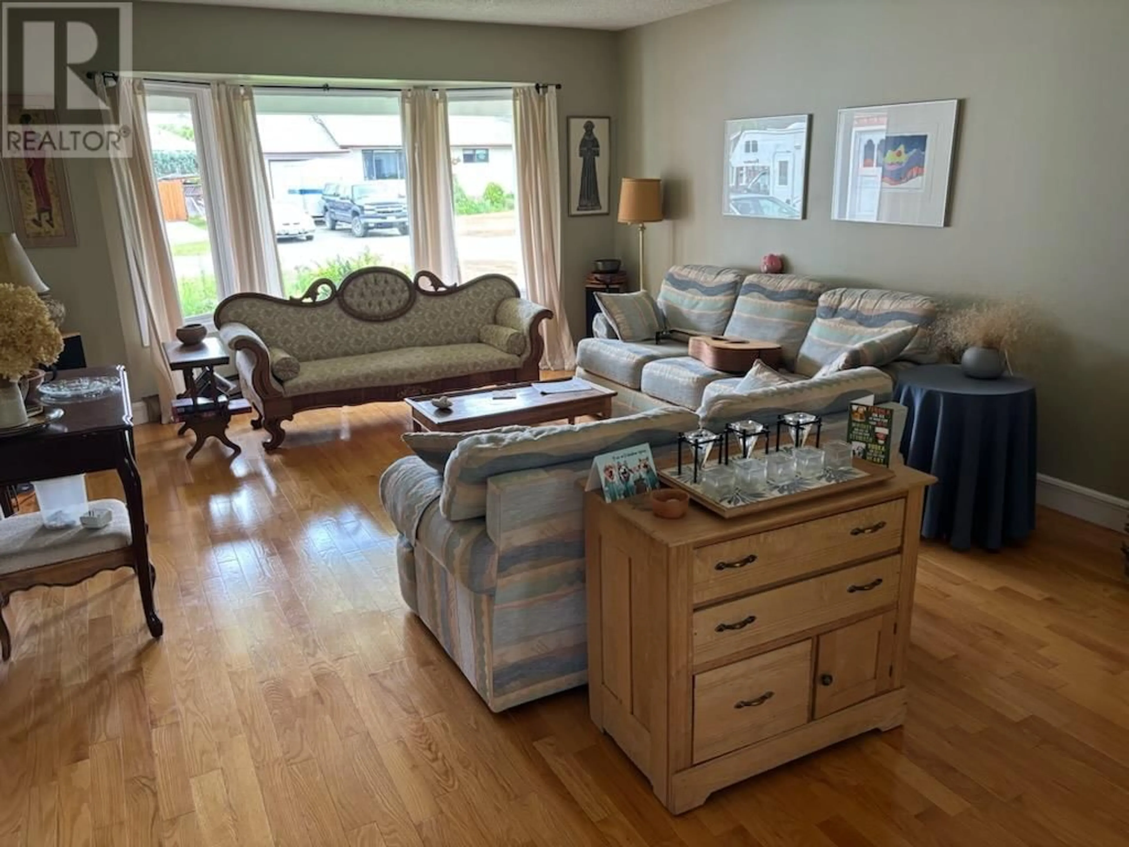 Living room with furniture, wood/laminate floor for 7749 17TH STREET, Grand Forks British Columbia V0H1H2