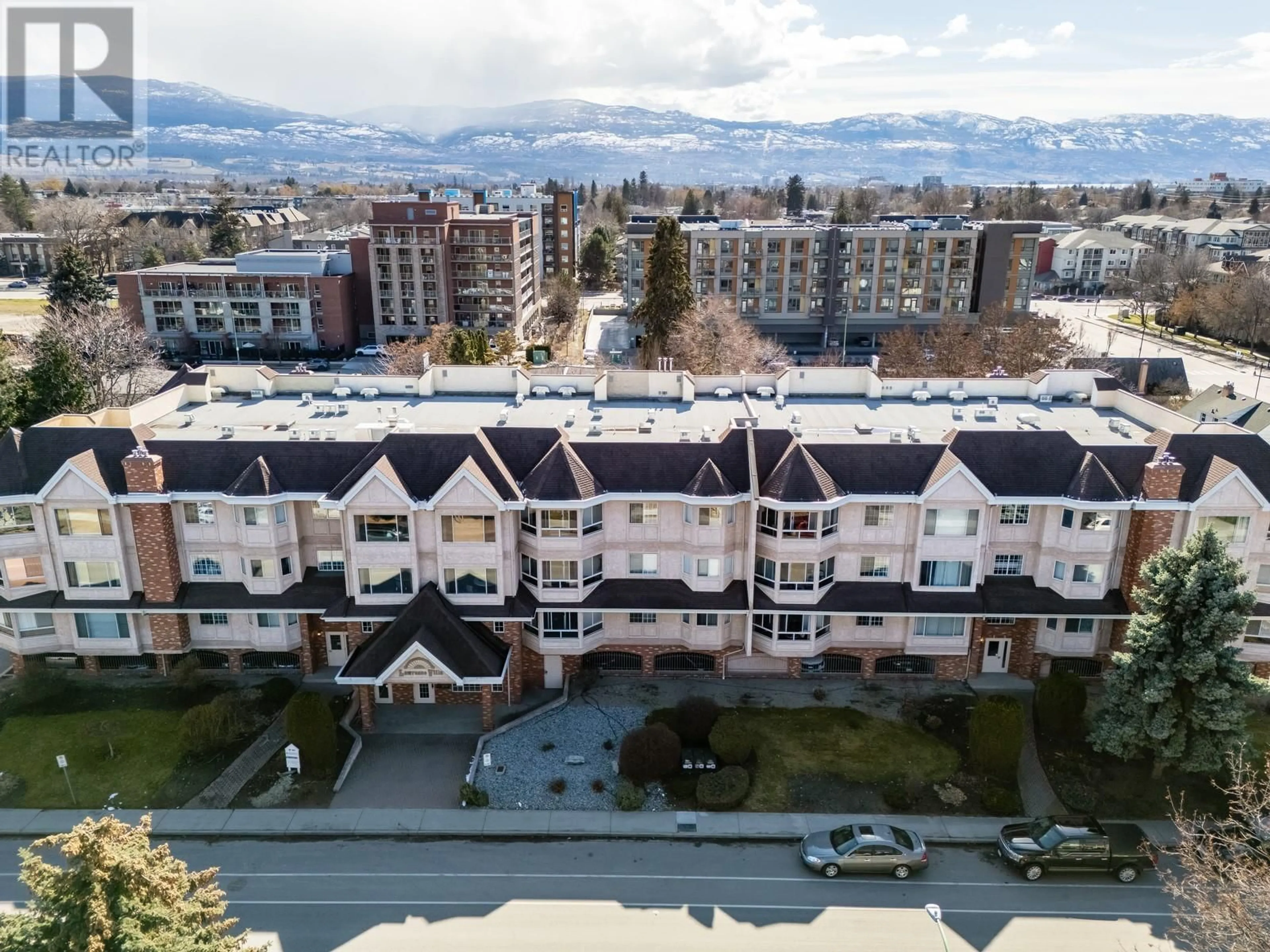 A pic from outside/outdoor area/front of a property/back of a property/a pic from drone, mountain view for 104 - 945 LAWRENCE AVENUE, Kelowna British Columbia V1Y6M3