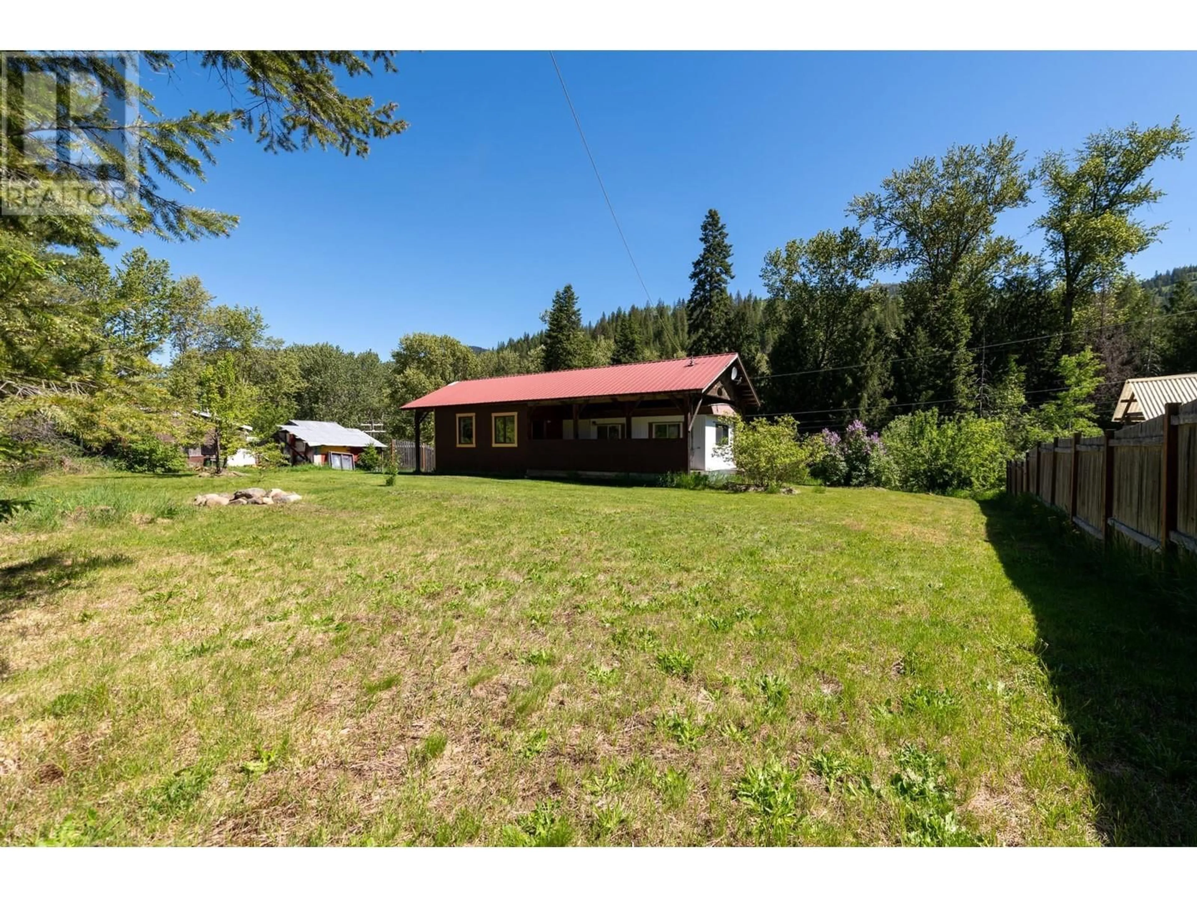 A pic from outside/outdoor area/front of a property/back of a property/a pic from drone, unknown for 7604 1ST AVENUE, Ymir British Columbia V0G2K0