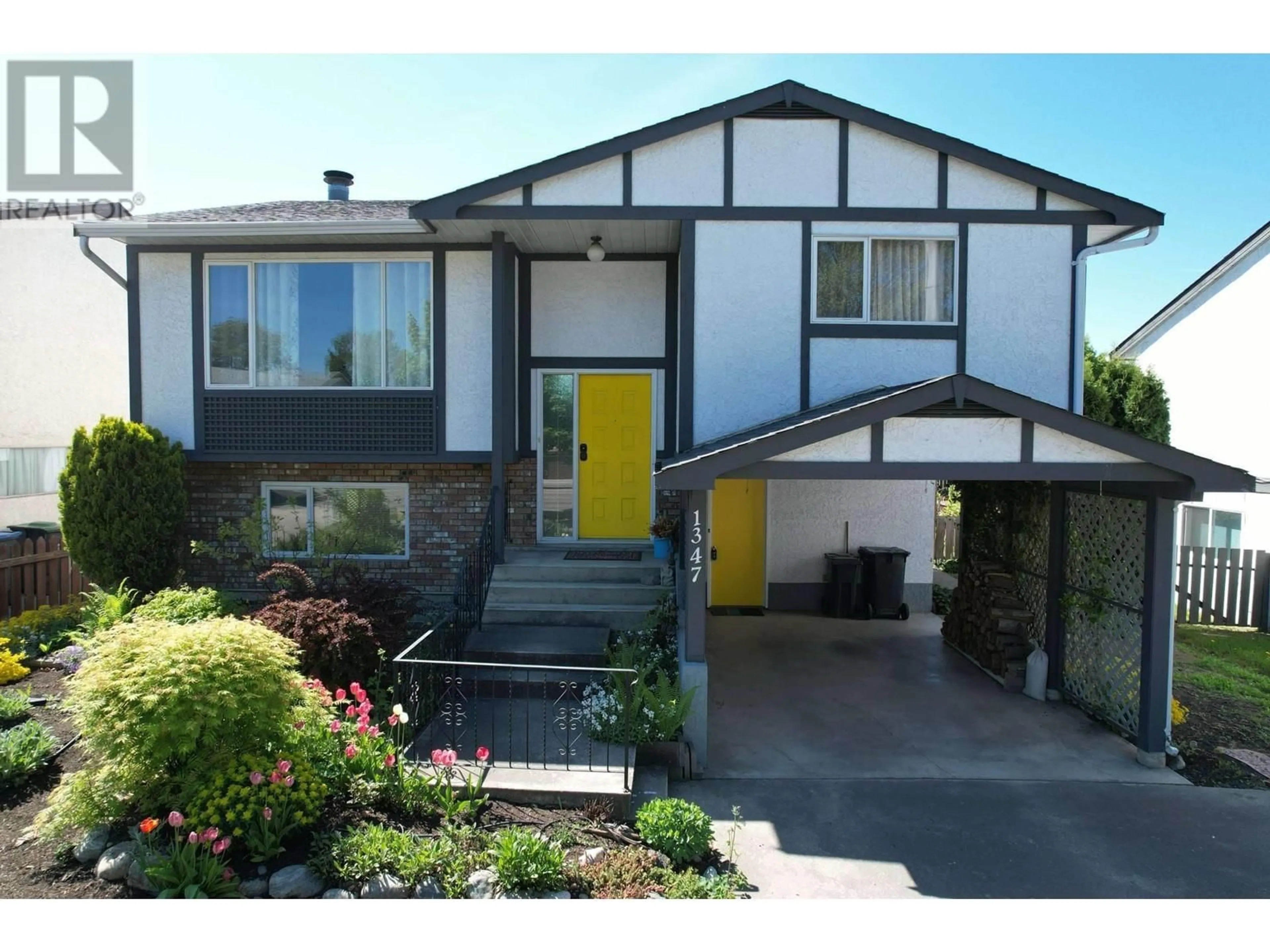 Home with vinyl exterior material, street for 1347 SPRINGFIELD ROAD, Kelowna British Columbia V1Y5V2