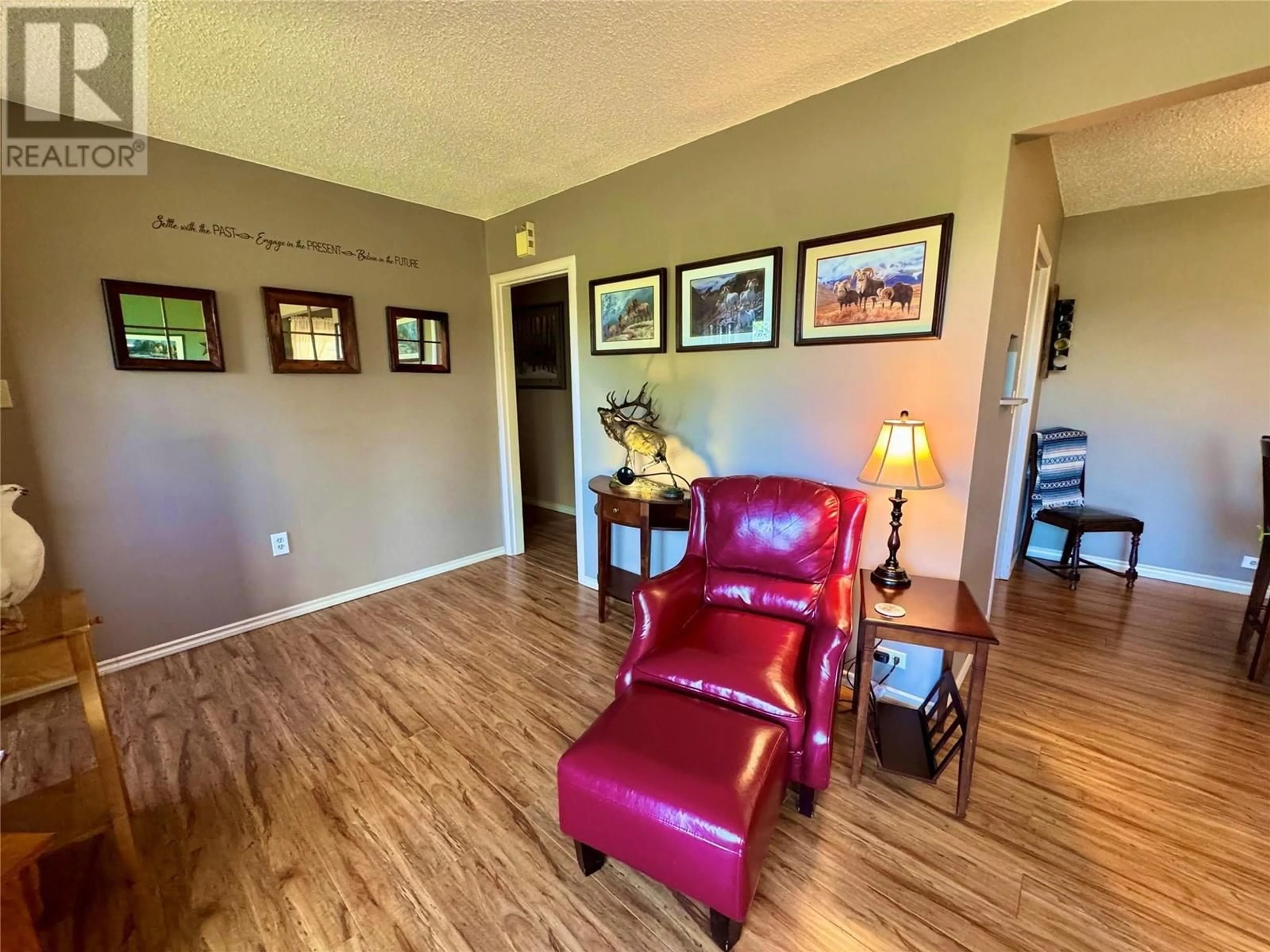 Living room with furniture, wood/laminate floor for 921 110 AVENUE, Dawson Creek British Columbia V1G2W1