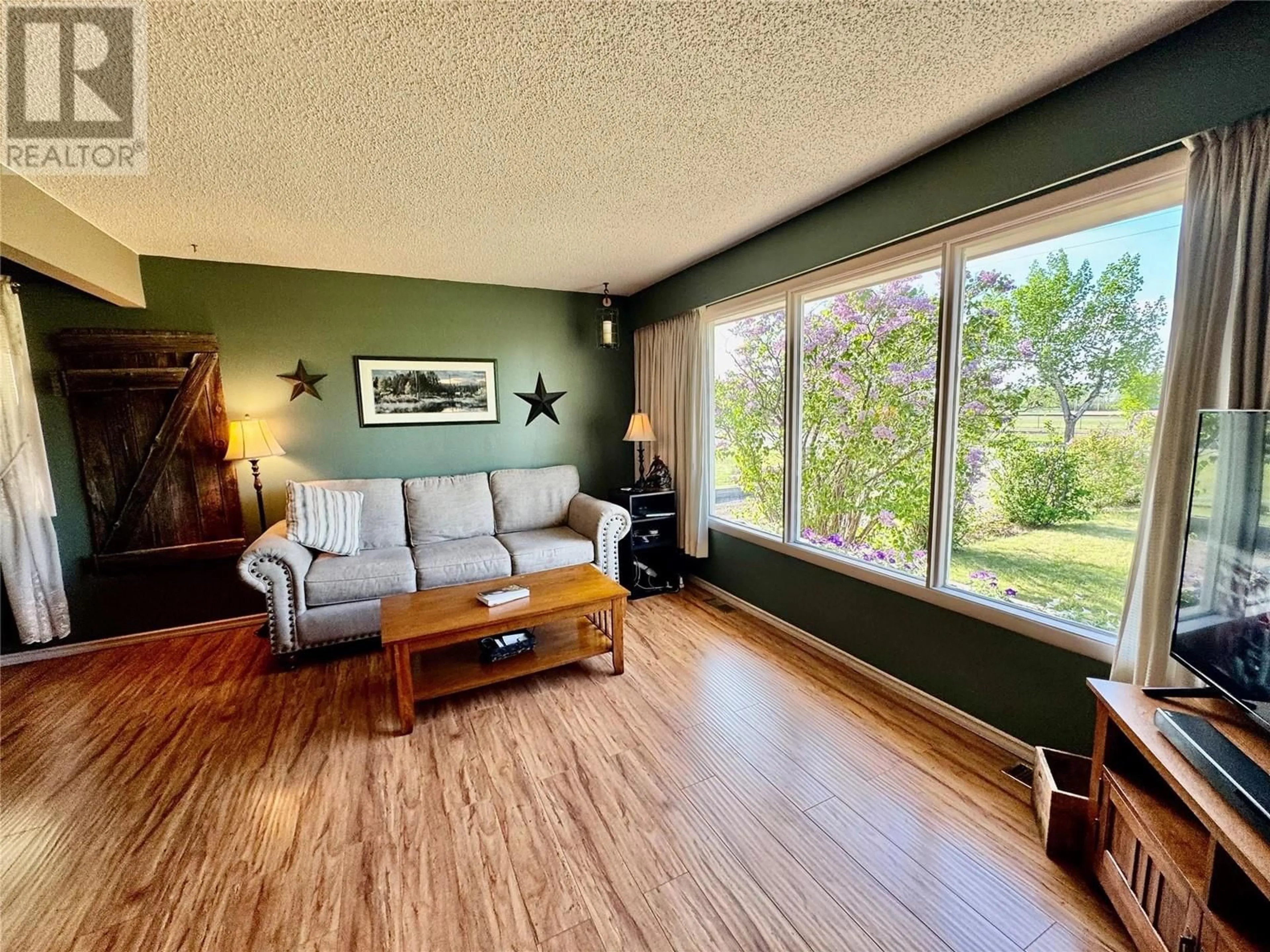 Living room with furniture, wood/laminate floor for 921 110 AVENUE, Dawson Creek British Columbia V1G2W1