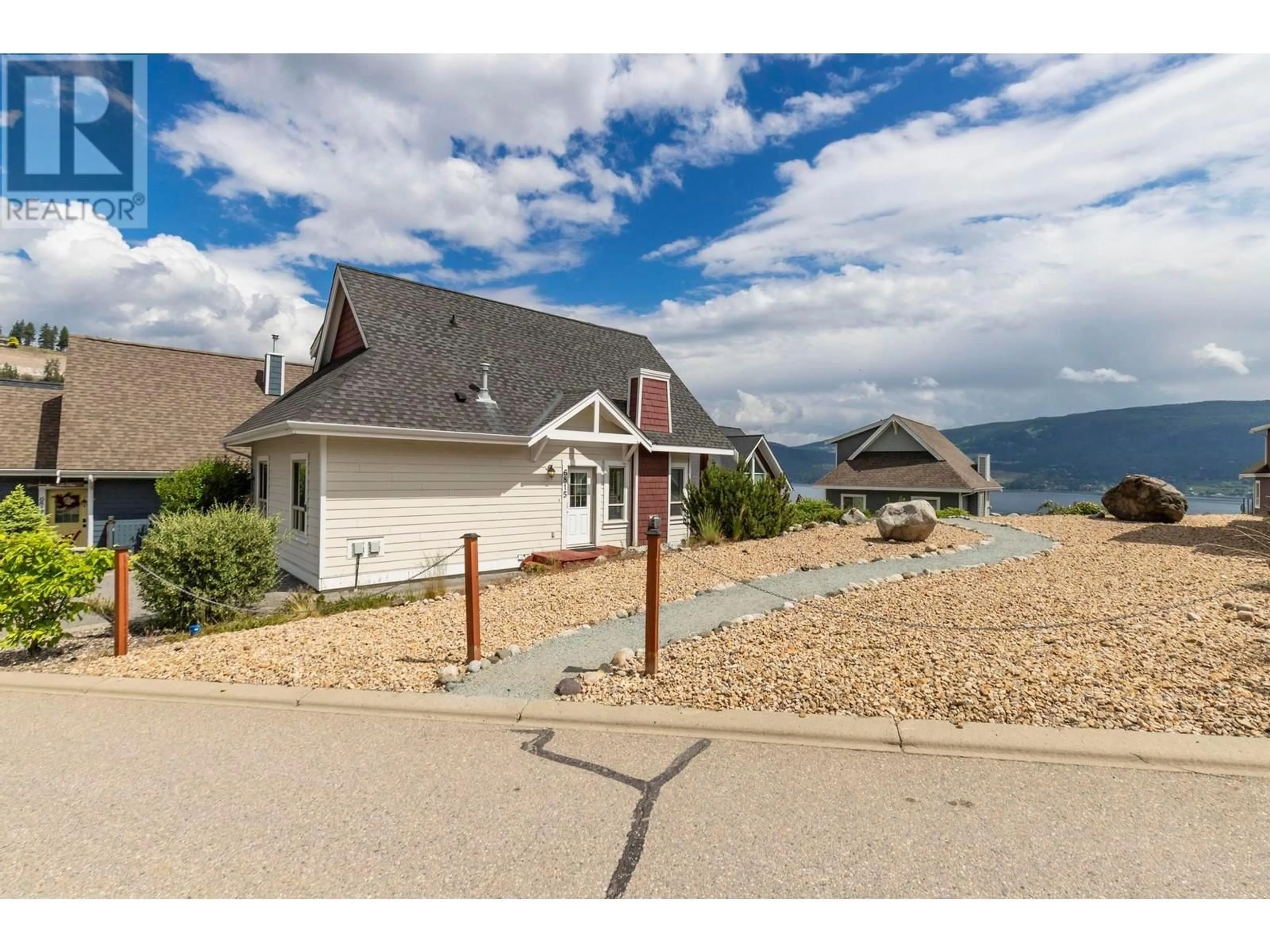 A pic from outside/outdoor area/front of a property/back of a property/a pic from drone, mountain view for 6815 SANTIAGO LOOP, Kelowna British Columbia V1Z3R8