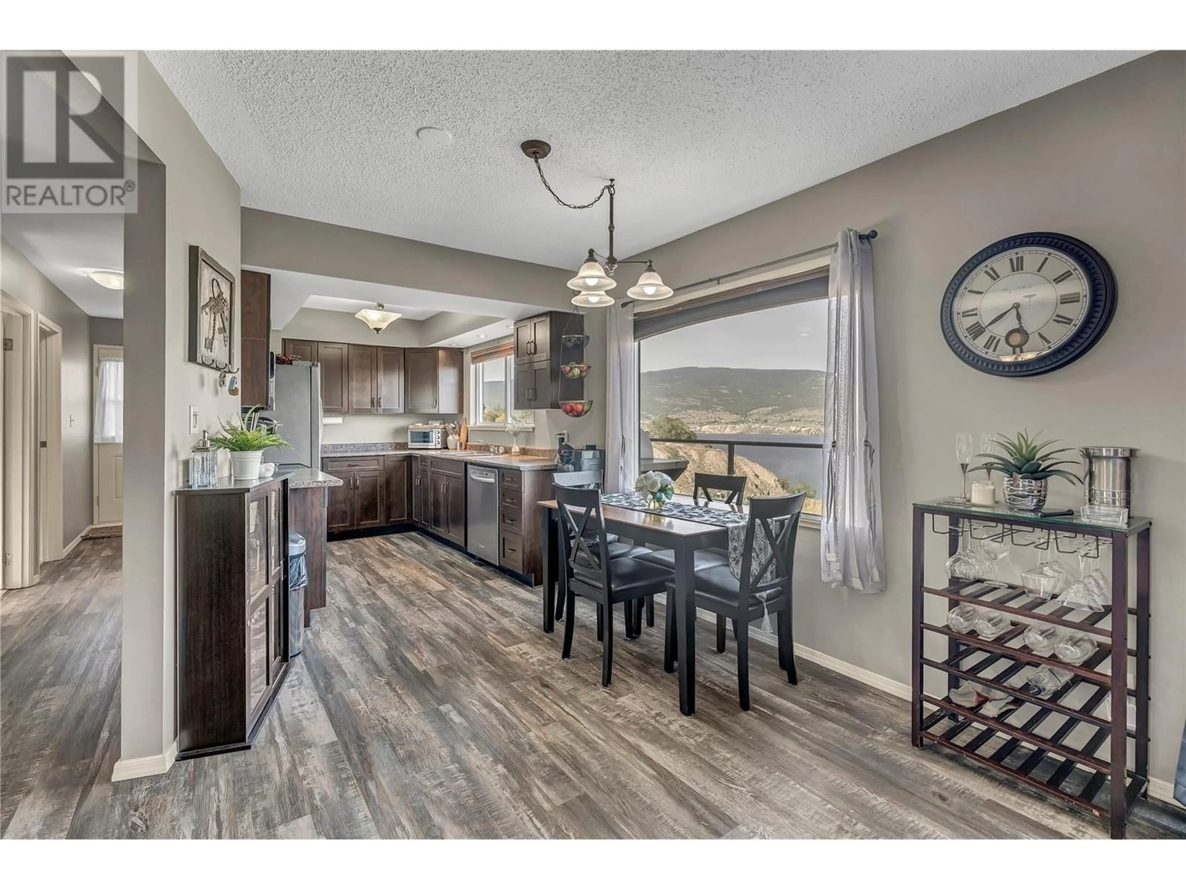 Open concept kitchen, wood/laminate floor for 320 SAGE MESA DRIVE, Penticton British Columbia V2A9A2