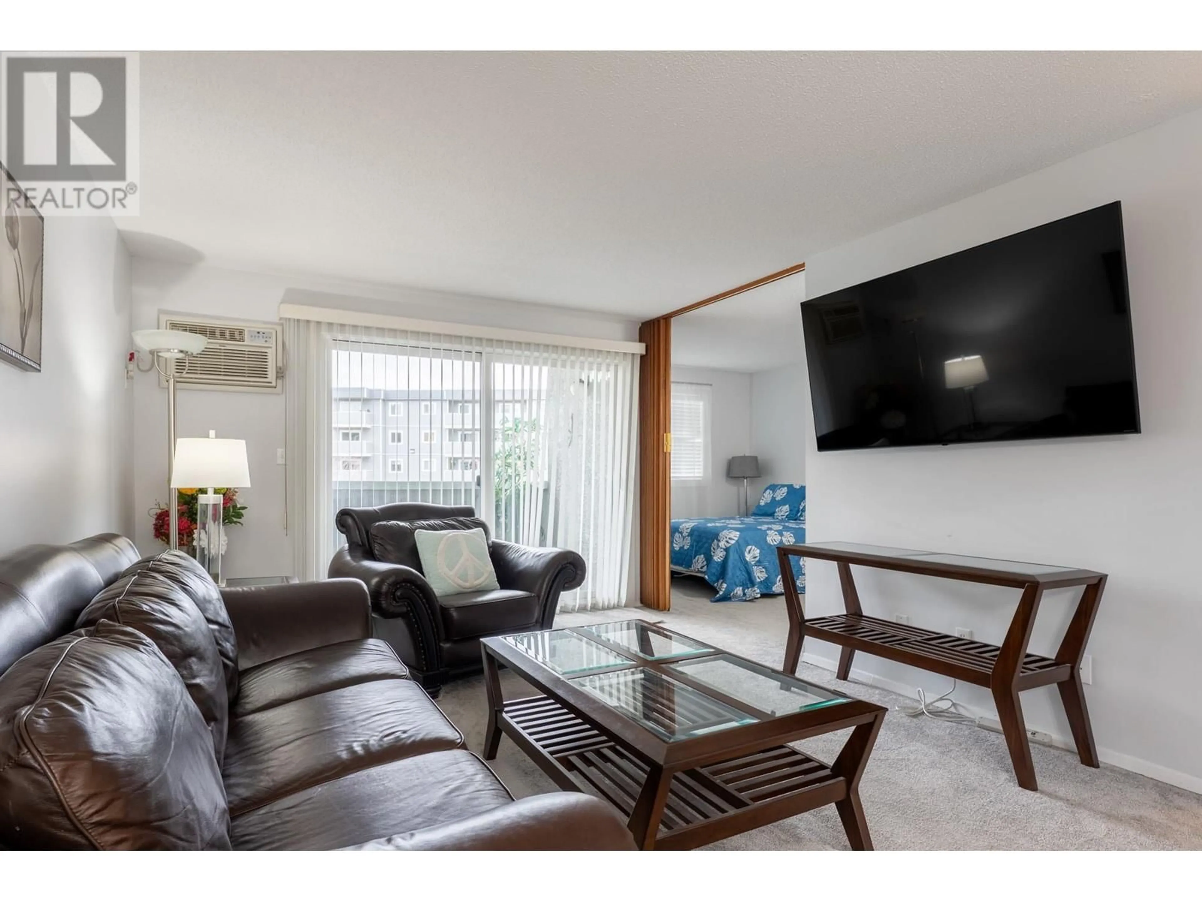 Living room with furniture, wood/laminate floor for 251 - 715 LEATHEAD ROAD, Kelowna British Columbia V1X5W3