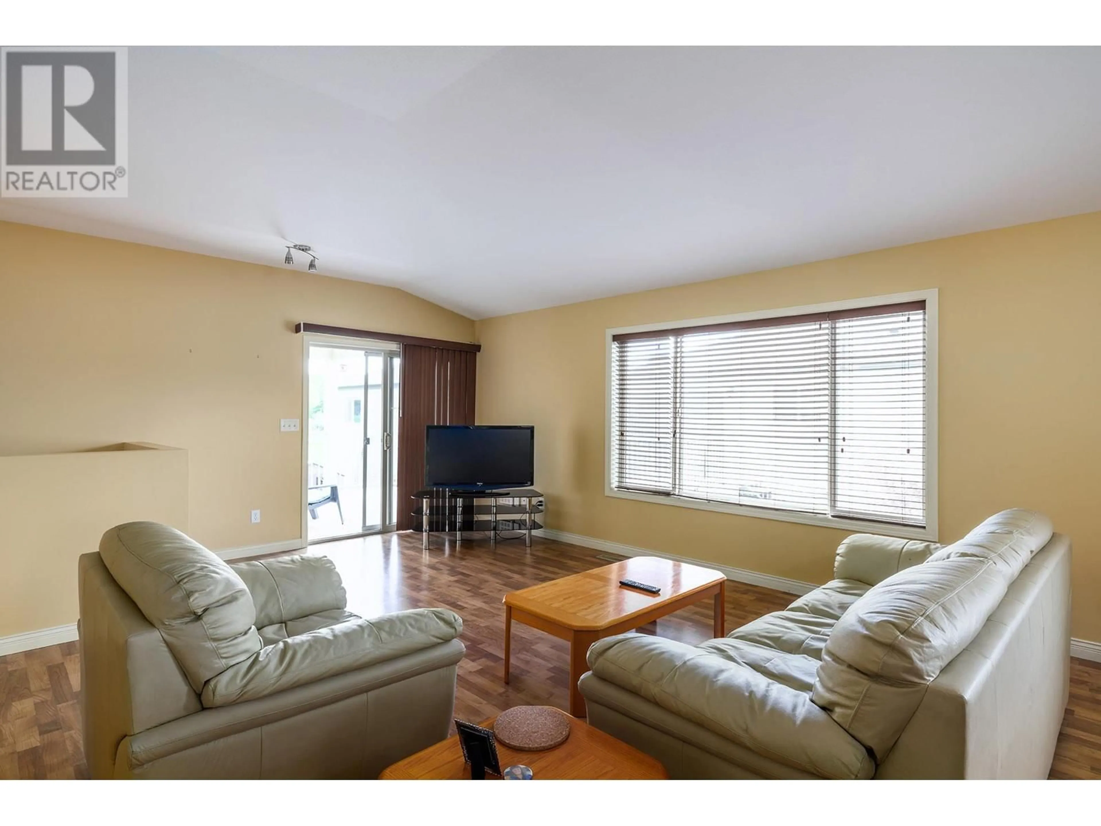 Living room with furniture, wood/laminate floor for 13 - 11392 LODGE ROAD, Lake Country British Columbia V4V1X2