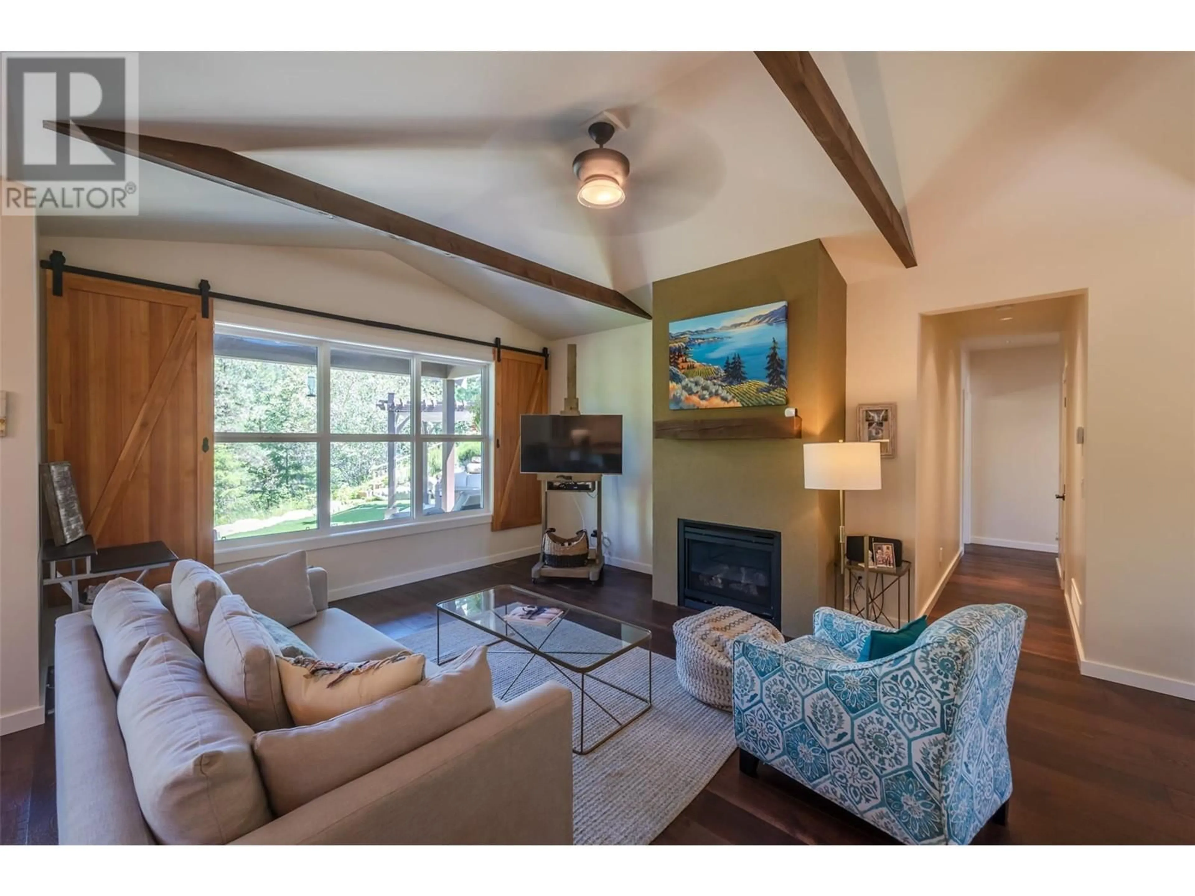 Living room with furniture, wood/laminate floor for 3175 JUNIPER DRIVE, Naramata British Columbia V0H1N1