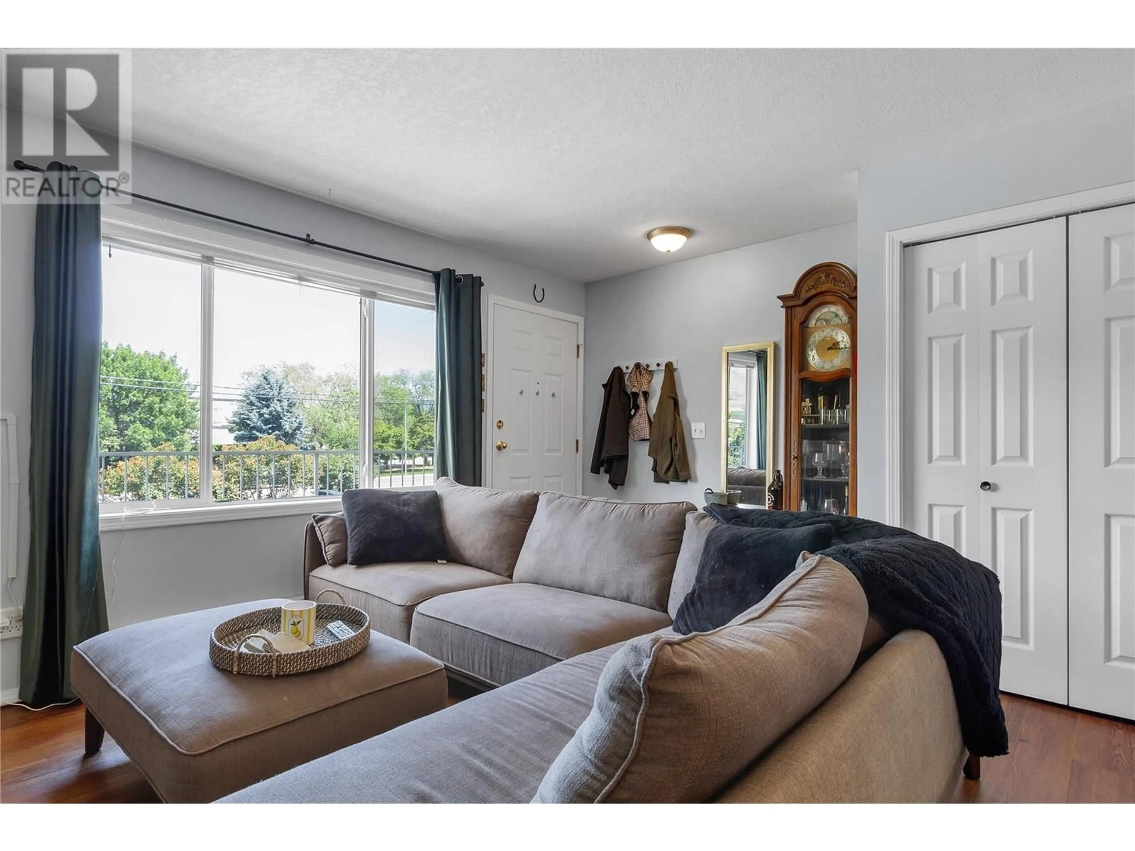 Living room with furniture, wood/laminate floor for 204 - 3802 25 AVENUE, Vernon British Columbia V1T1P3