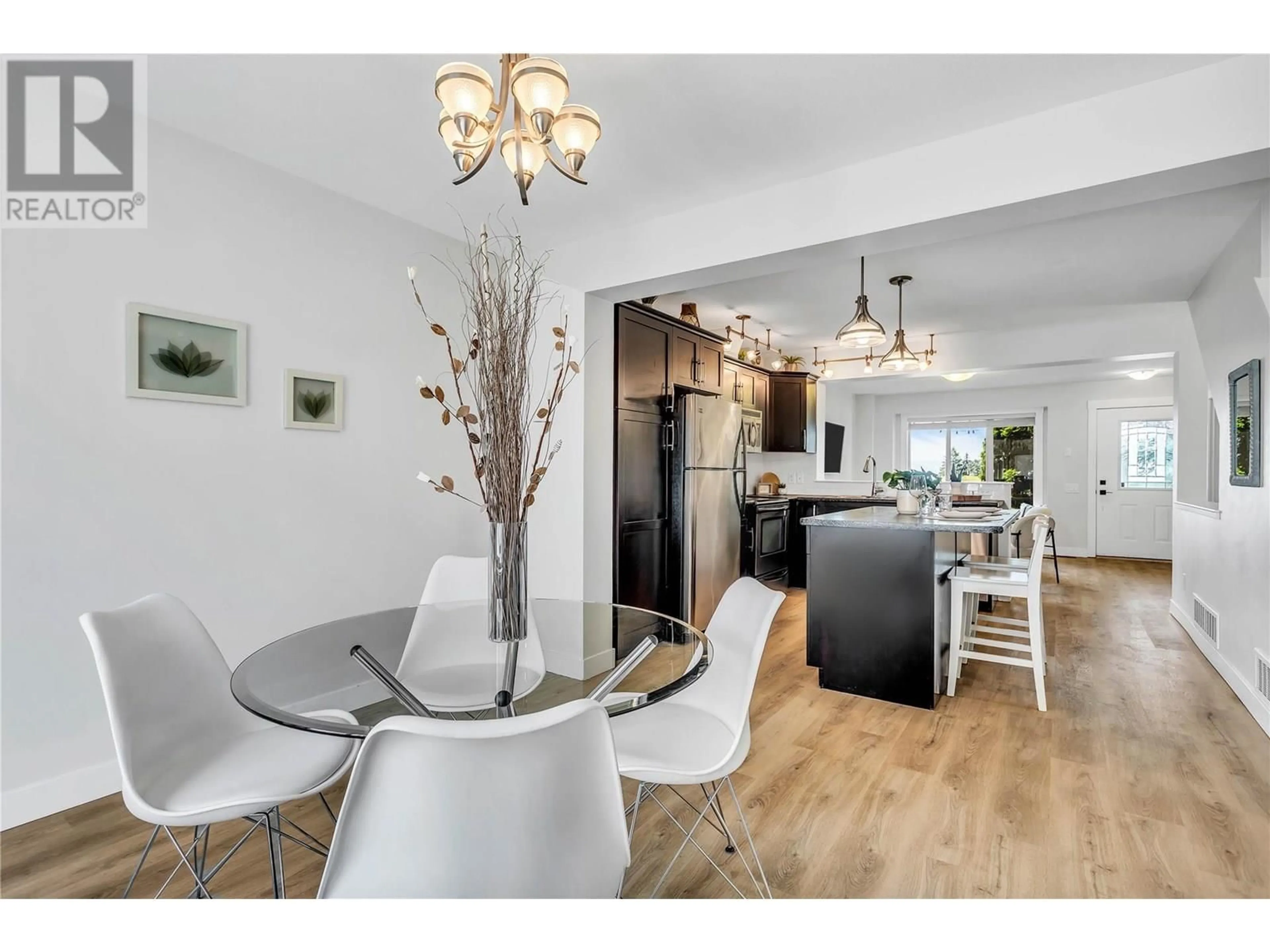 Open concept kitchen, wood/laminate floor for 114 - 1651 LYNRICK ROAD, Kelowna British Columbia V1P1R4