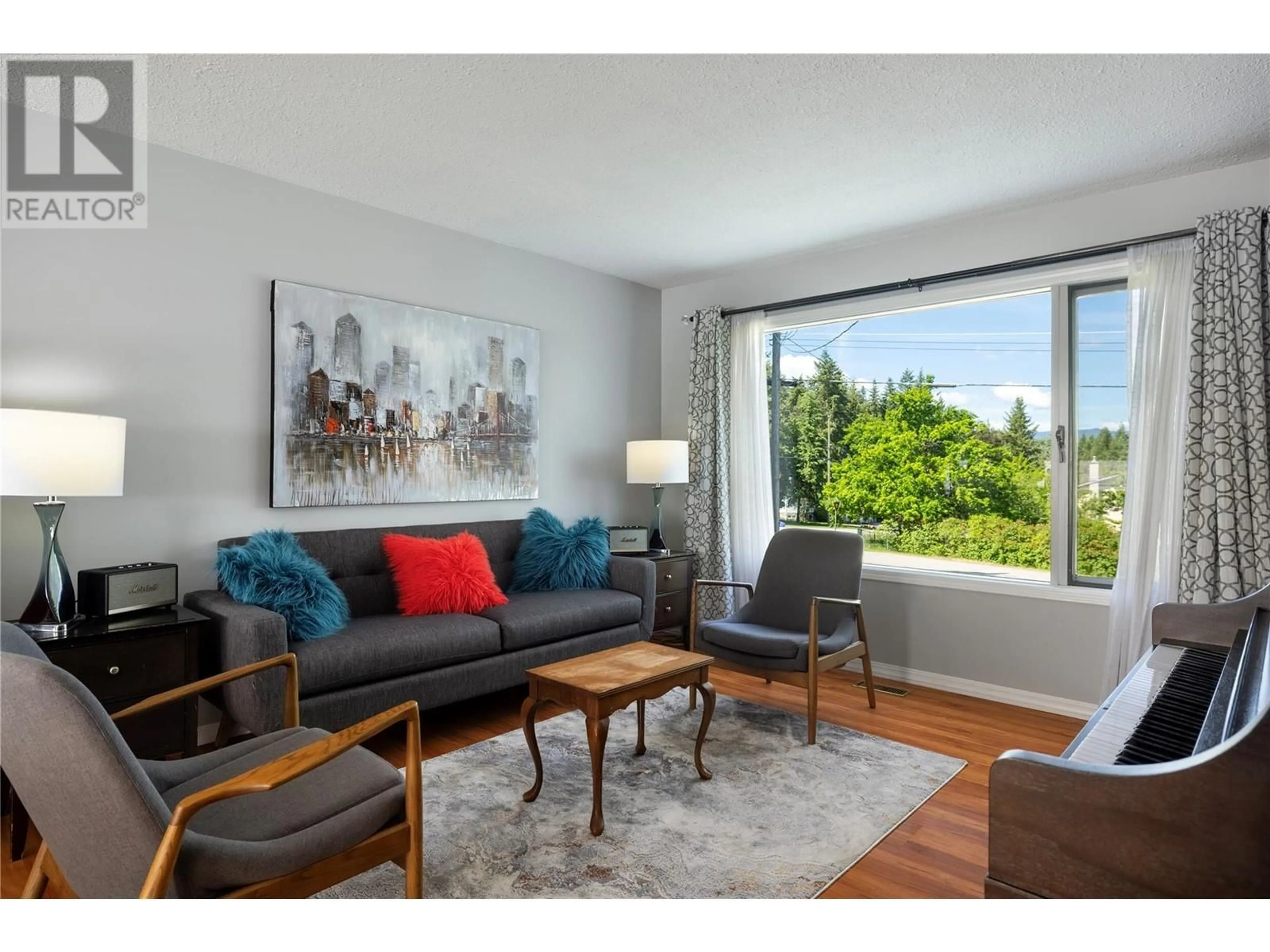 Living room with furniture, wood/laminate floor for 3429 LARCH DRIVE, Spallumcheen British Columbia V4Y0S8