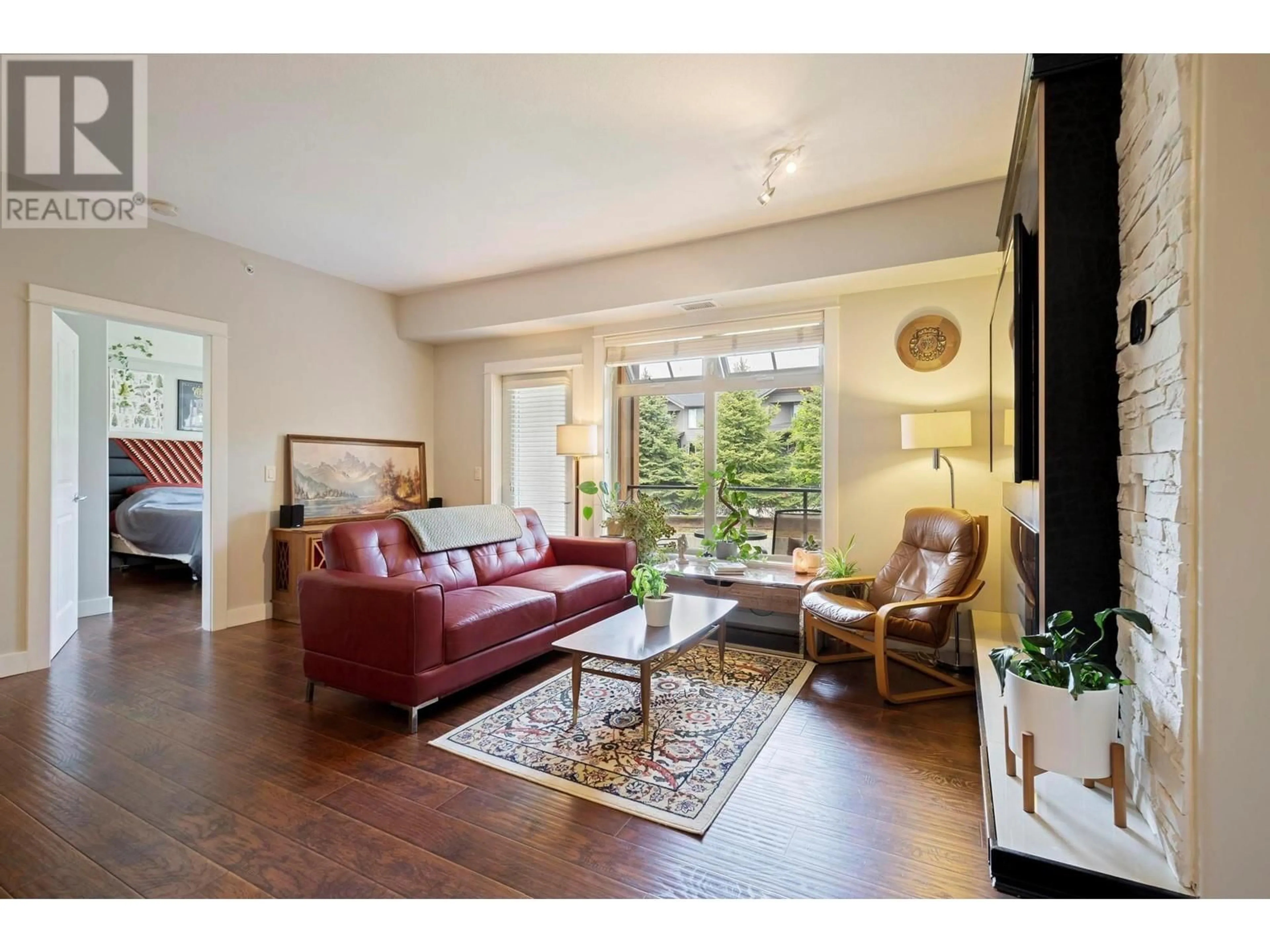 Living room with furniture, wood/laminate floor for 214 - 2611 STILLWATER WAY, Lake Country British Columbia V4V2R3