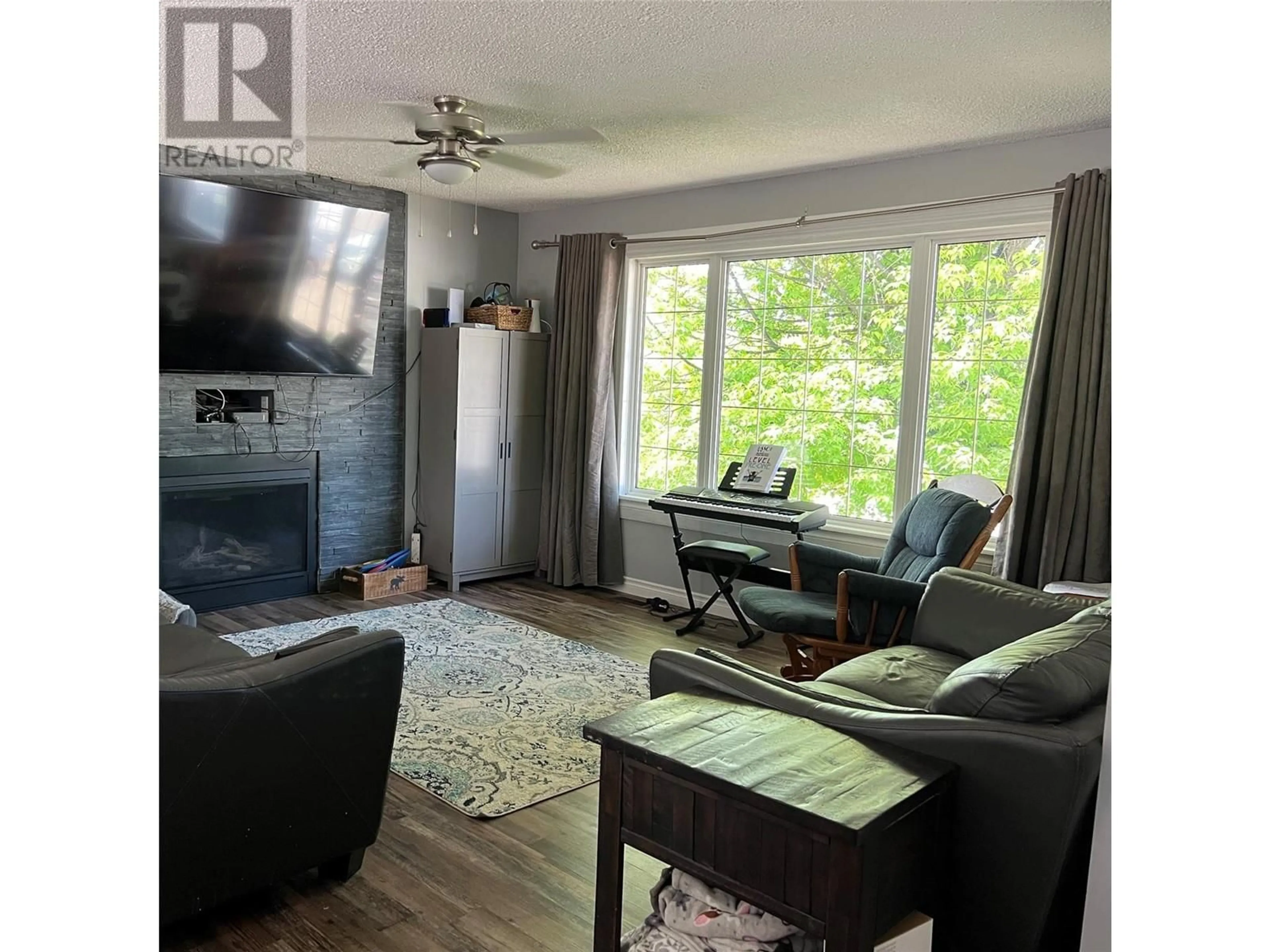 Living room with furniture, wood/laminate floor for 5118 43A STREET NORTHEAST, Chetwynd British Columbia V0C1J0