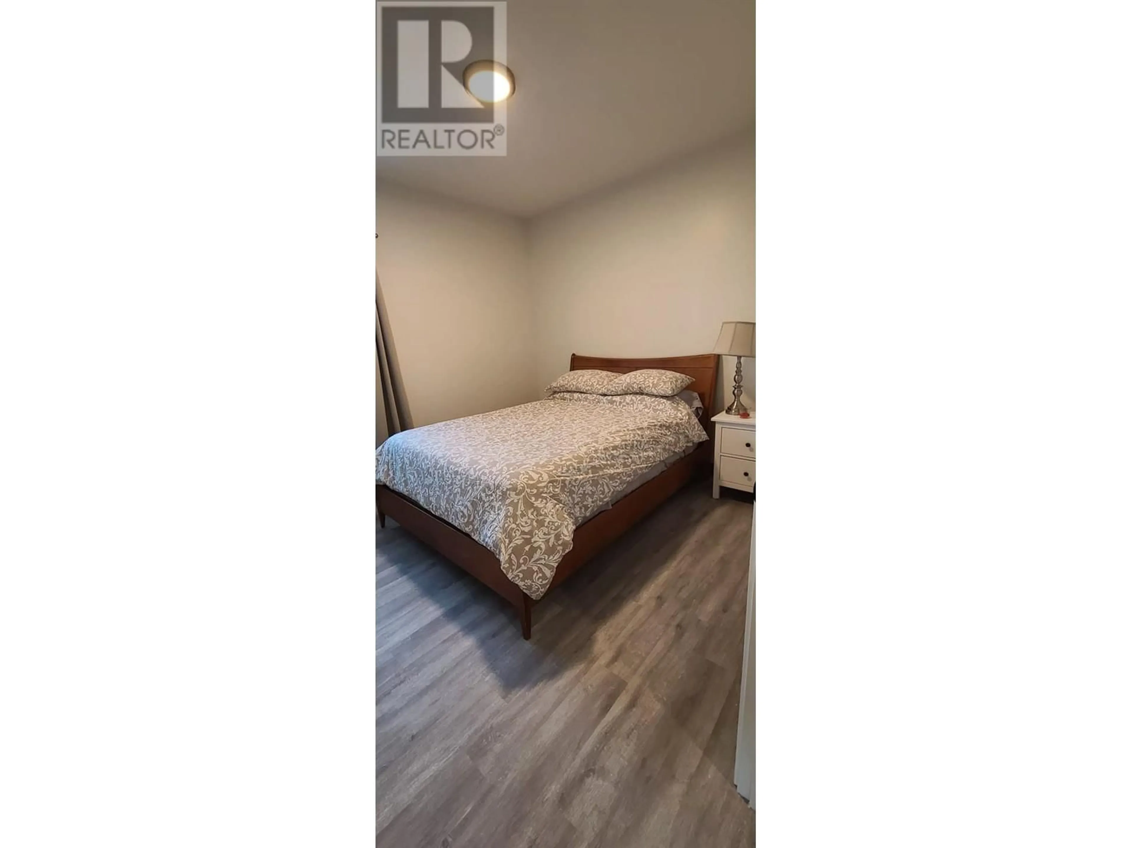 Bedroom with bed, wood/laminate floor for 6074 JACKSON CRESCENT, Peachland British Columbia V0H1X4