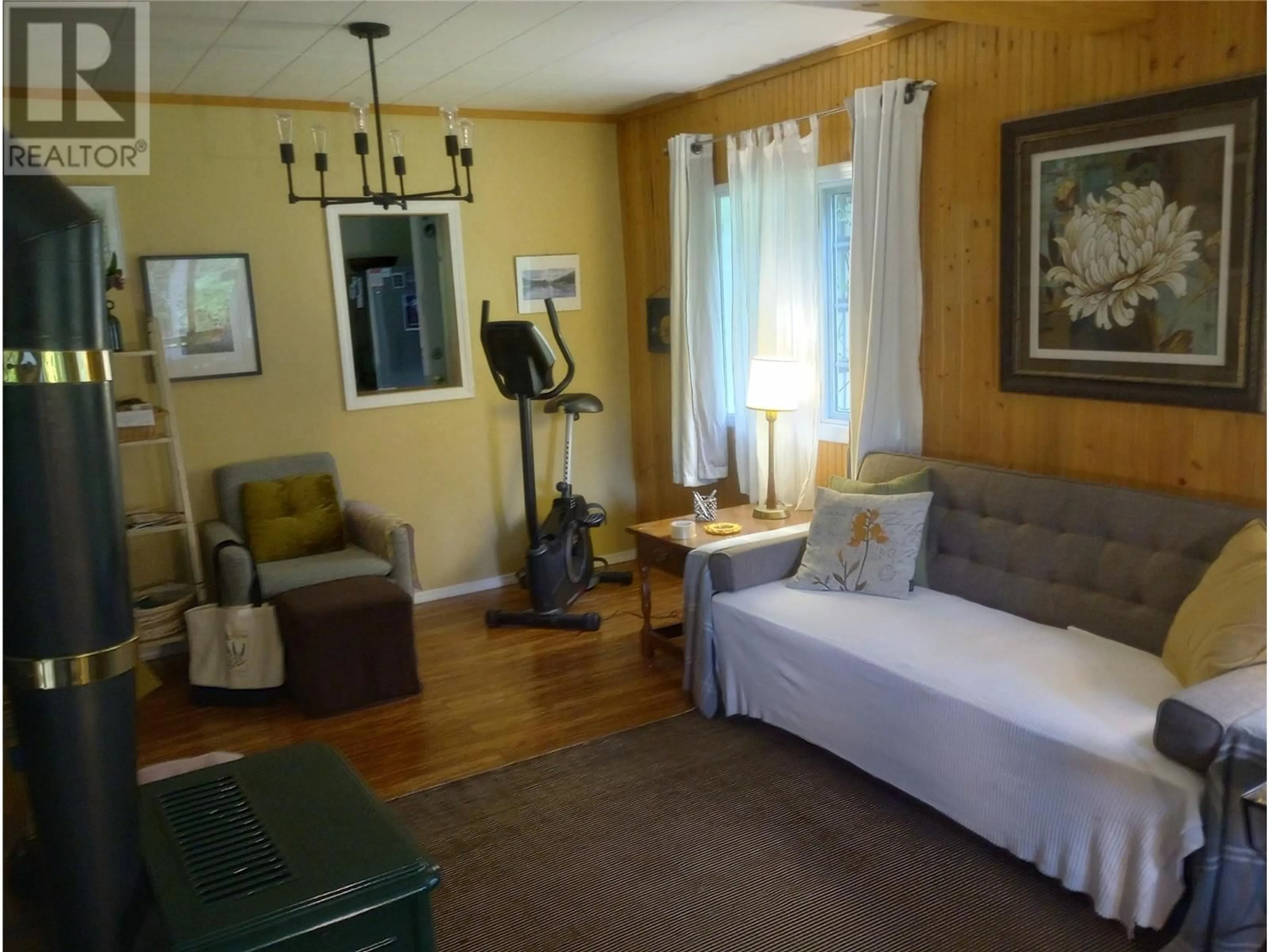 Living room with furniture, wood/laminate floor for 7812 6 HIGHWAY, Fauquier British Columbia V0G1K0