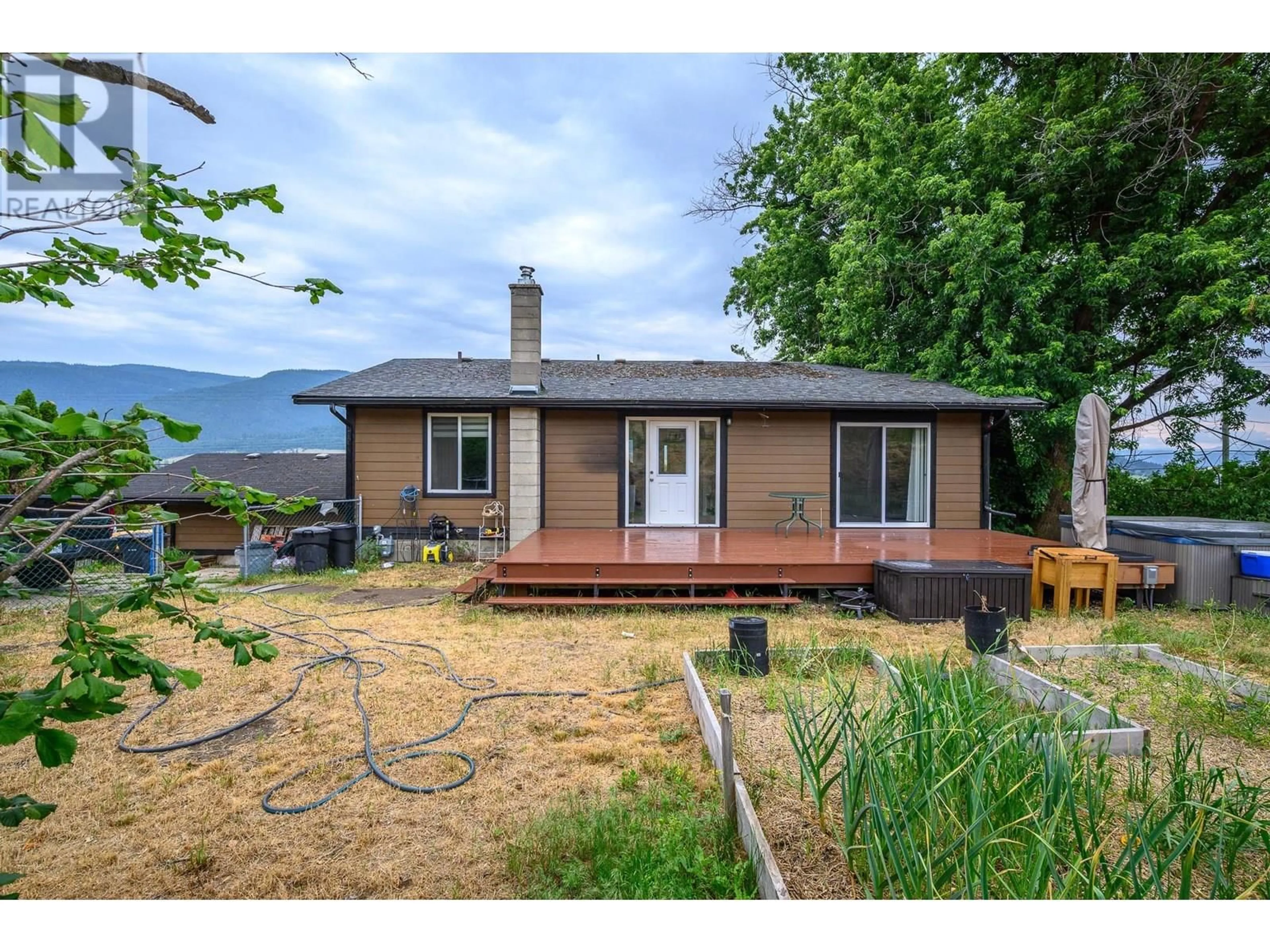 A pic from outside/outdoor area/front of a property/back of a property/a pic from drone, mountain view for 9221 6 HIGHWAY, Coldstream British Columbia V1B3B5
