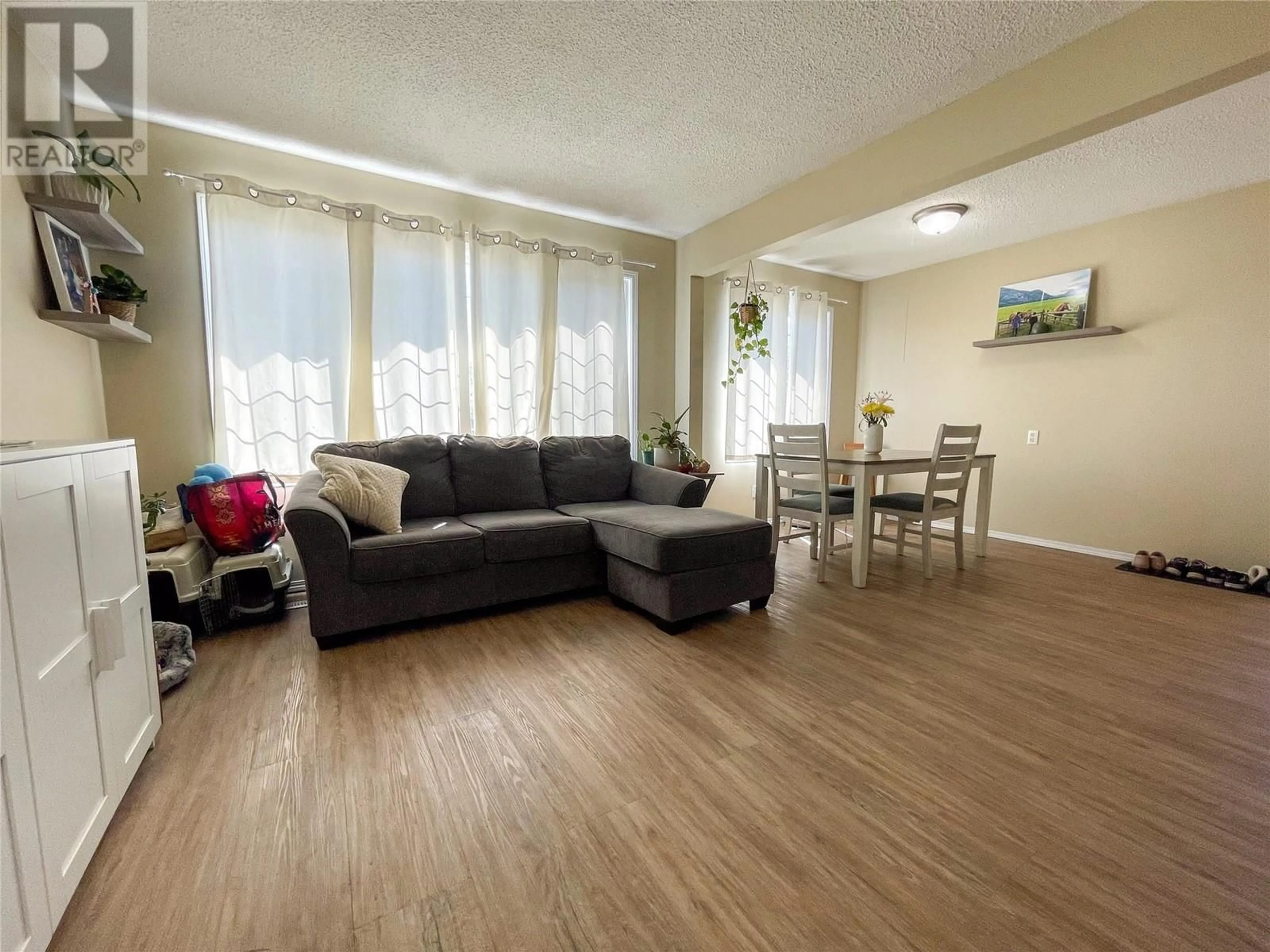 Living room with furniture, wood/laminate floor for 4820 48 AVENUE, Pouce Coupe British Columbia V0C2C0