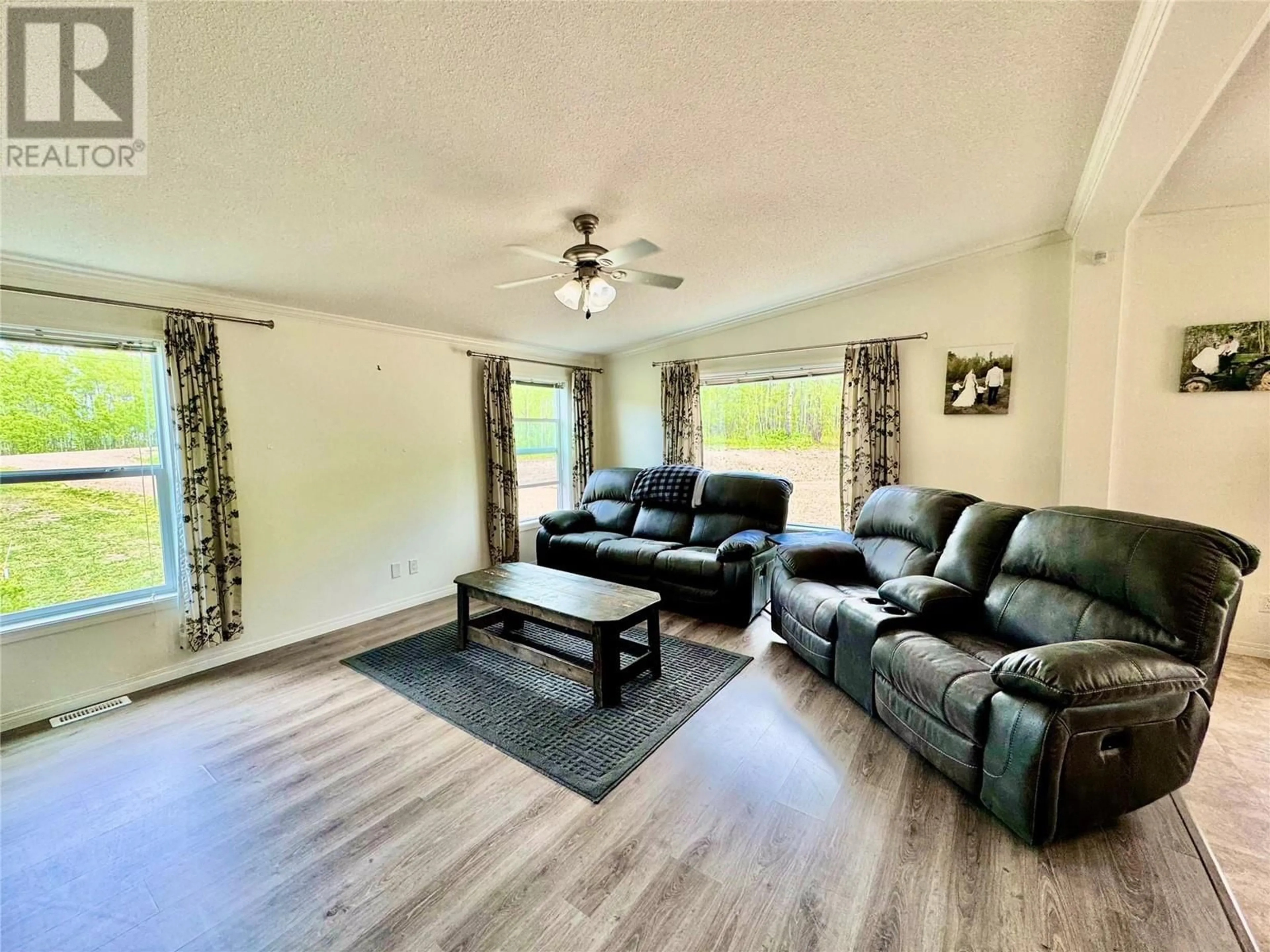 Living room with furniture, wood/laminate floor for 13167 MCKINNON WAY, Dawson Creek British Columbia V1G5A1