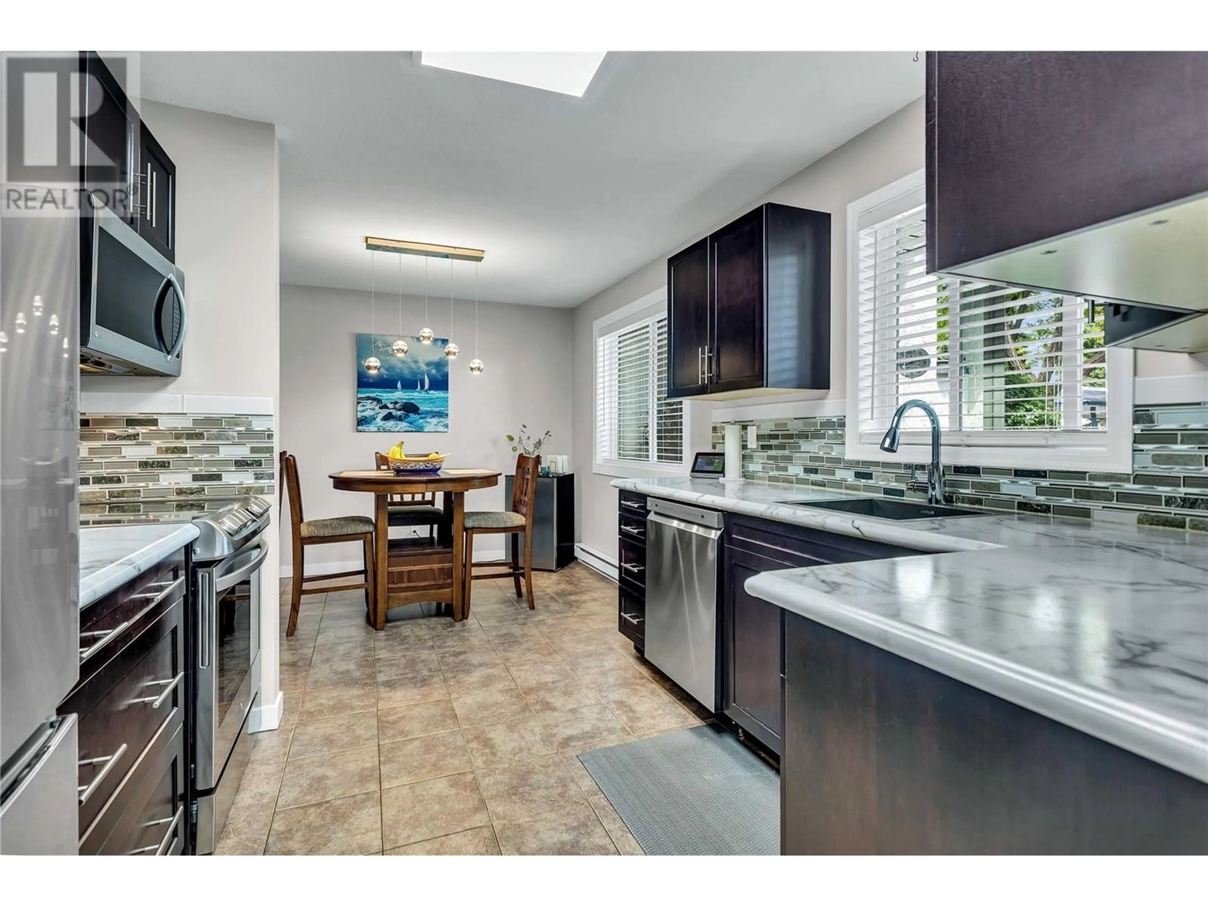 Open concept kitchen, ceramic/tile floor for 104 - 1480 TERAI ROAD, Kelowna British Columbia V1X7H3
