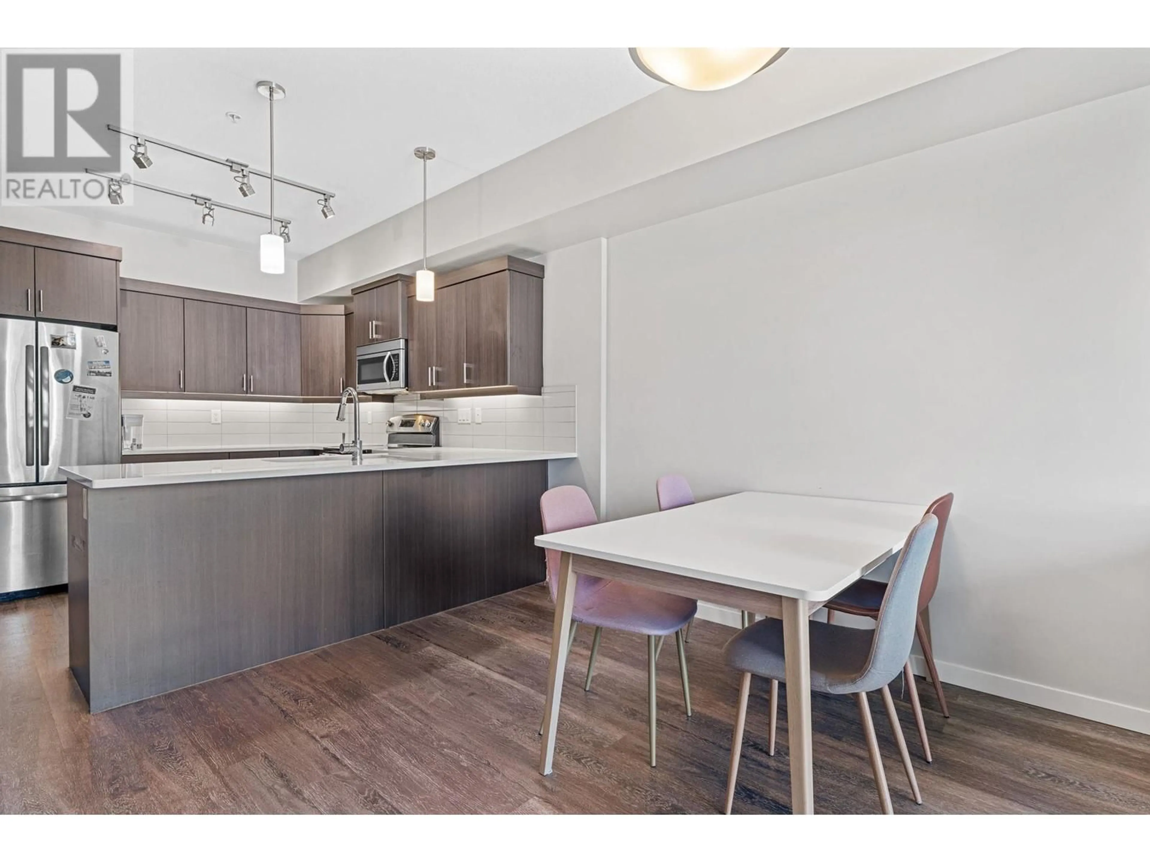 Open concept kitchen, wood/laminate floor for 210 - 3731 CASORSO ROAD, Kelowna British Columbia V1W5E9