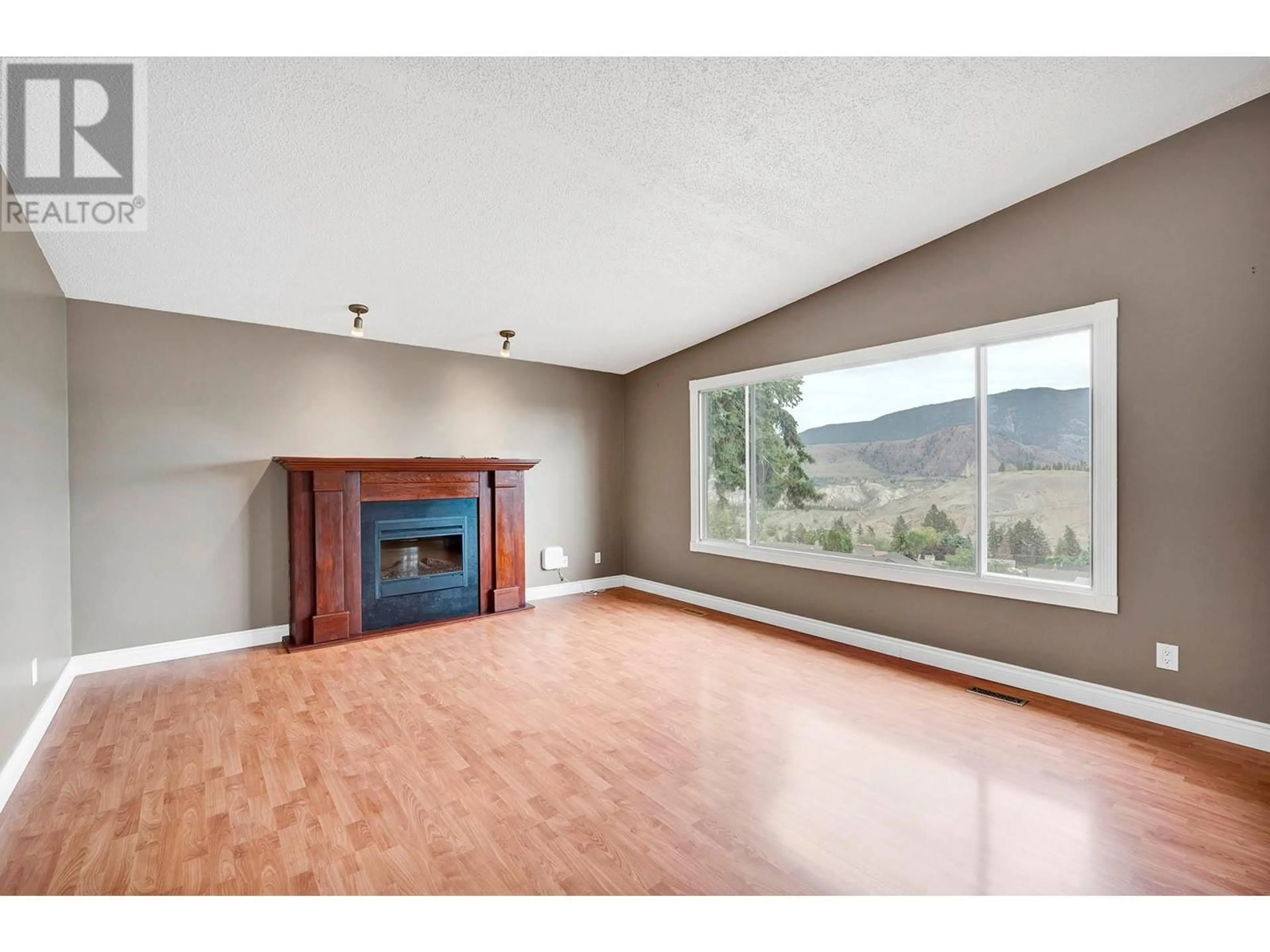 Living room with furniture, wood/laminate floor for 1297 BELAIR DRIVE, Kamloops British Columbia V2C5G3
