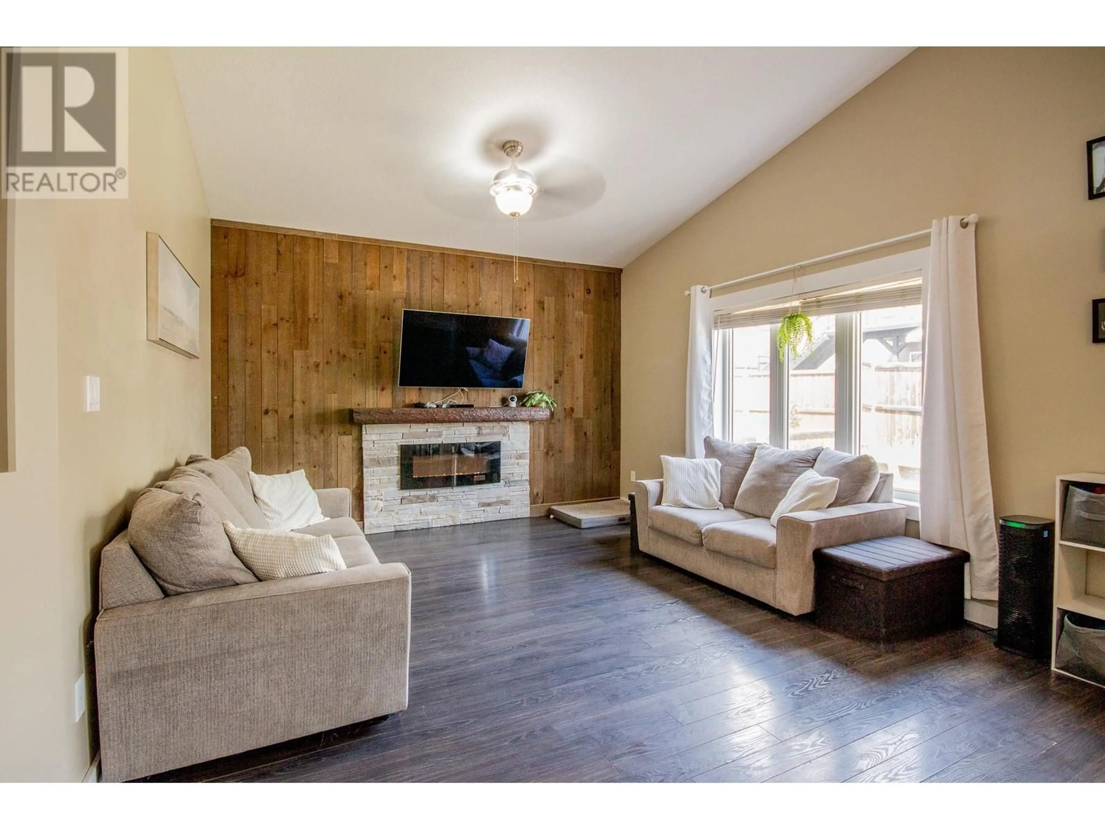 Living room with furniture, wood/laminate floor for 8412 18A STREET, Dawson Creek British Columbia V1G0E2