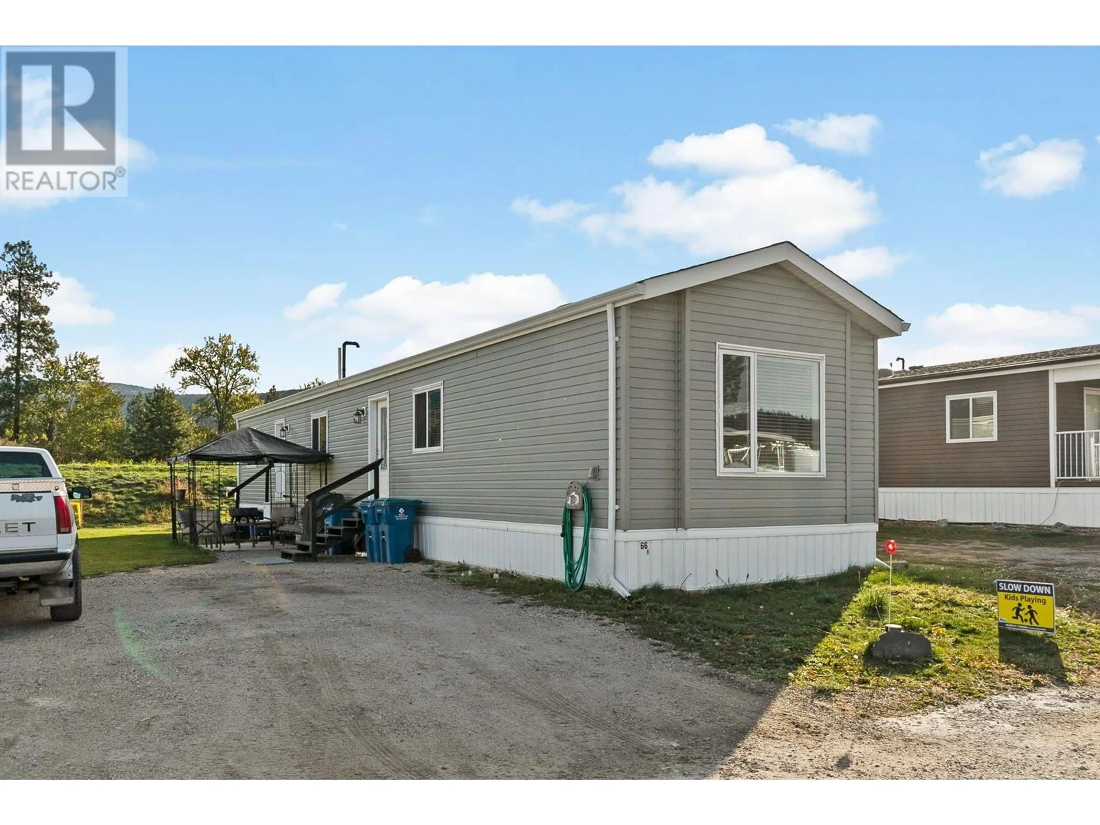 Home with vinyl exterior material, street for 66B - 8945 HWY 97N HIGHWAY, Kelowna British Columbia V4V1E8