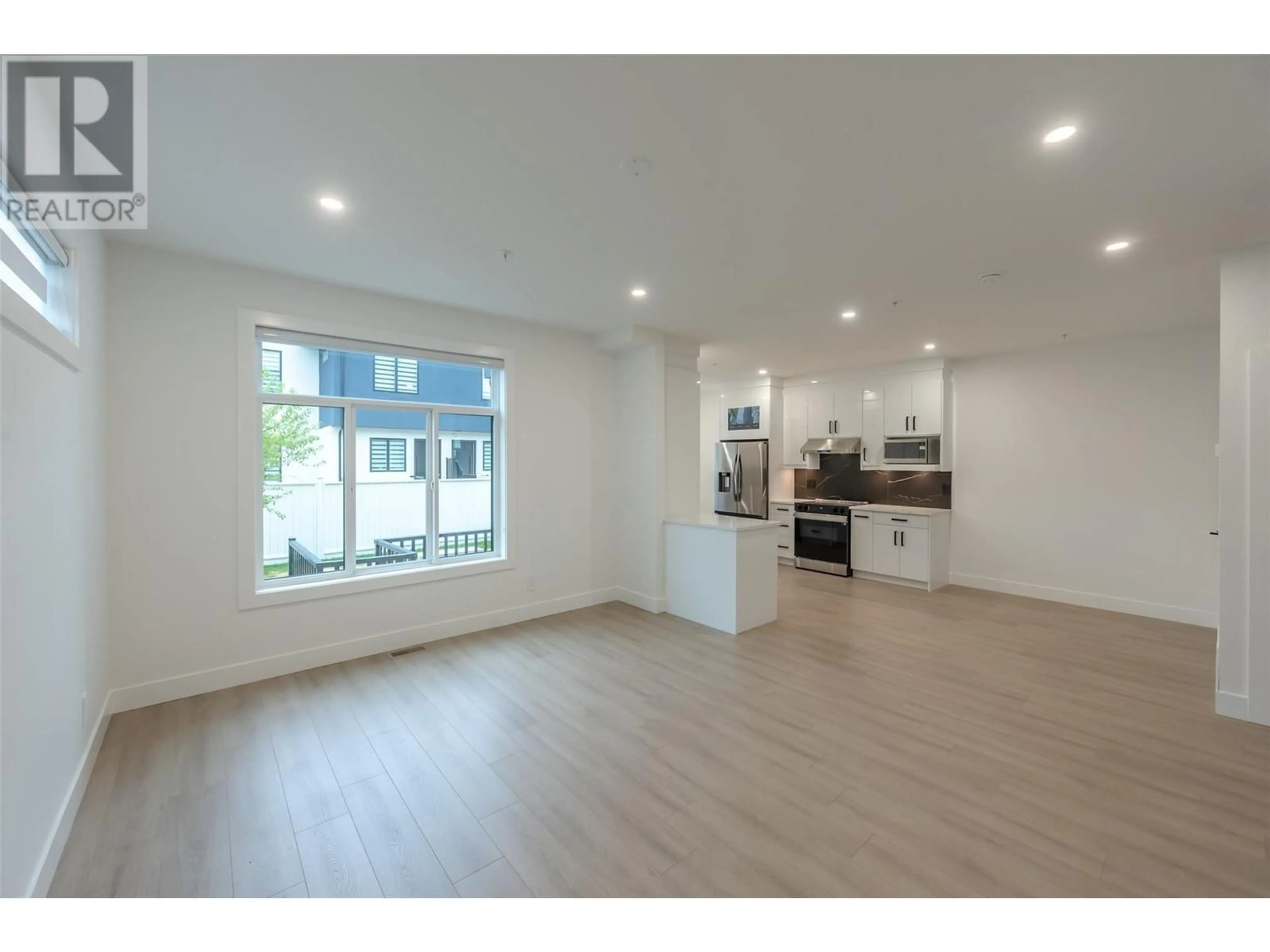 Open concept kitchen, wood/laminate floor for 103 - 60 ROY AVENUE, Penticton British Columbia V2A3M7