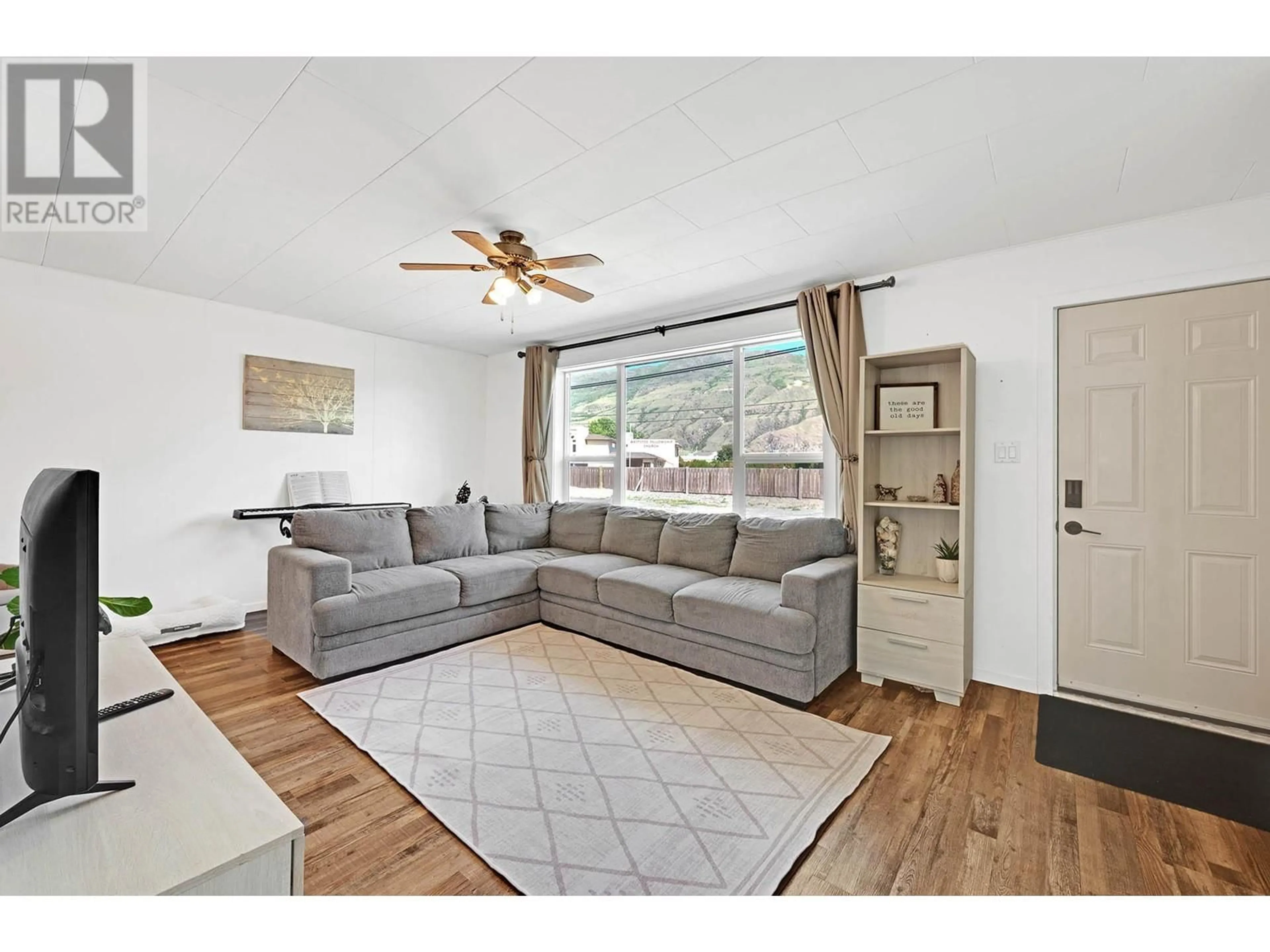 Living room with furniture, wood/laminate floor for 2820 WESTSYDE ROAD, Kamloops British Columbia V2B7E3