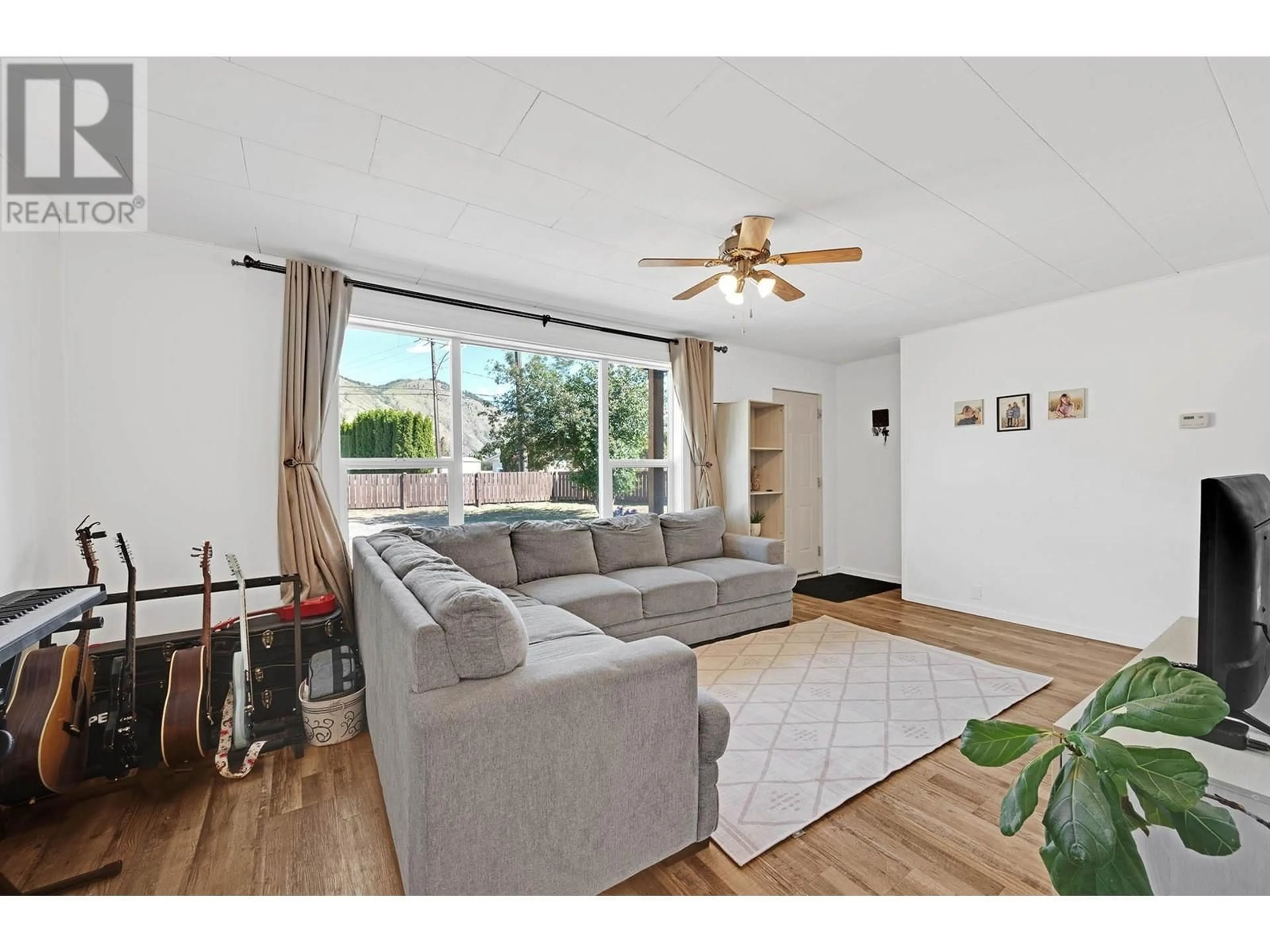Living room with furniture, wood/laminate floor for 2820 WESTSYDE ROAD, Kamloops British Columbia V2B7E3
