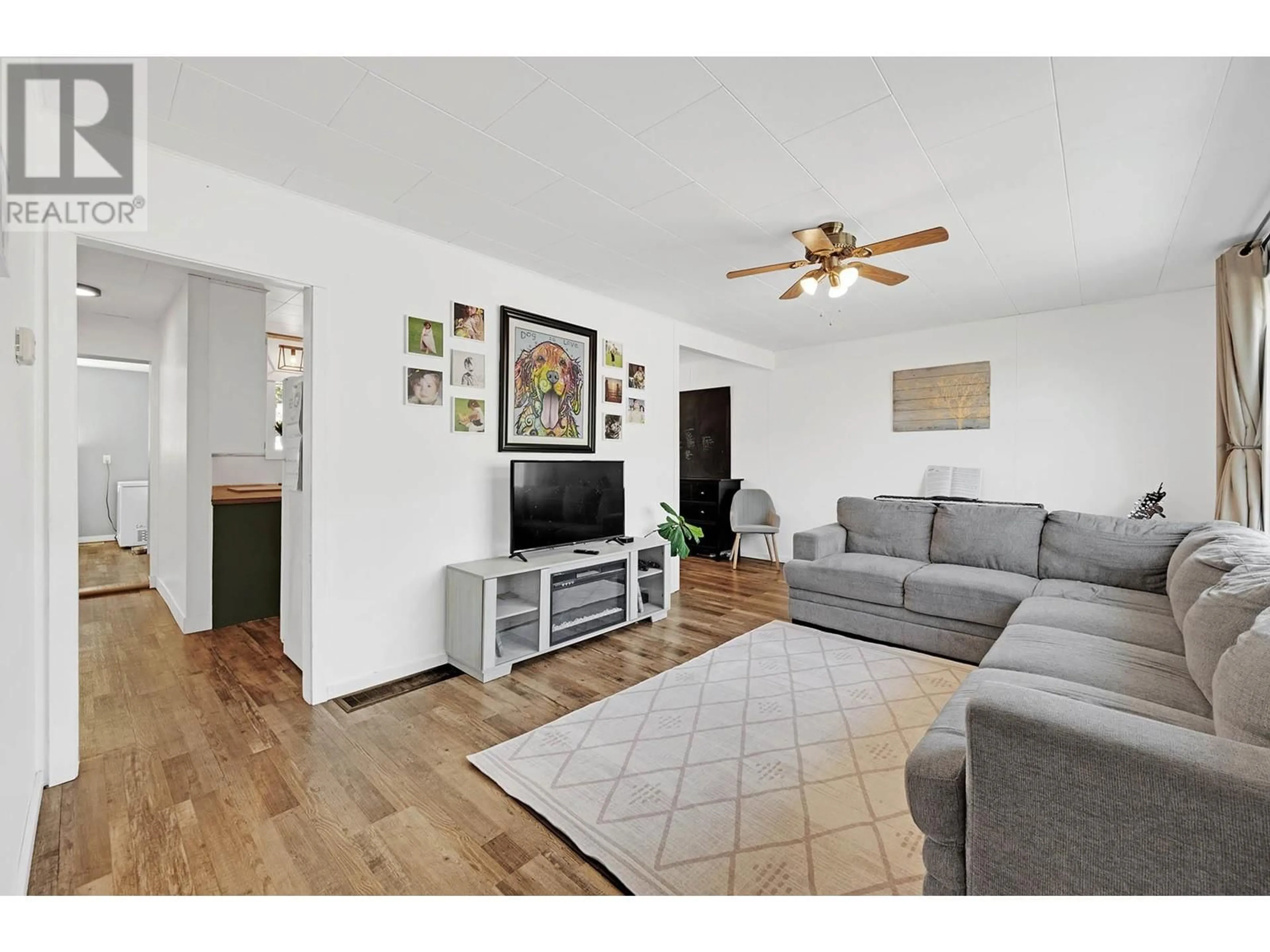Living room with furniture, wood/laminate floor for 2820 WESTSYDE ROAD, Kamloops British Columbia V2B7E3