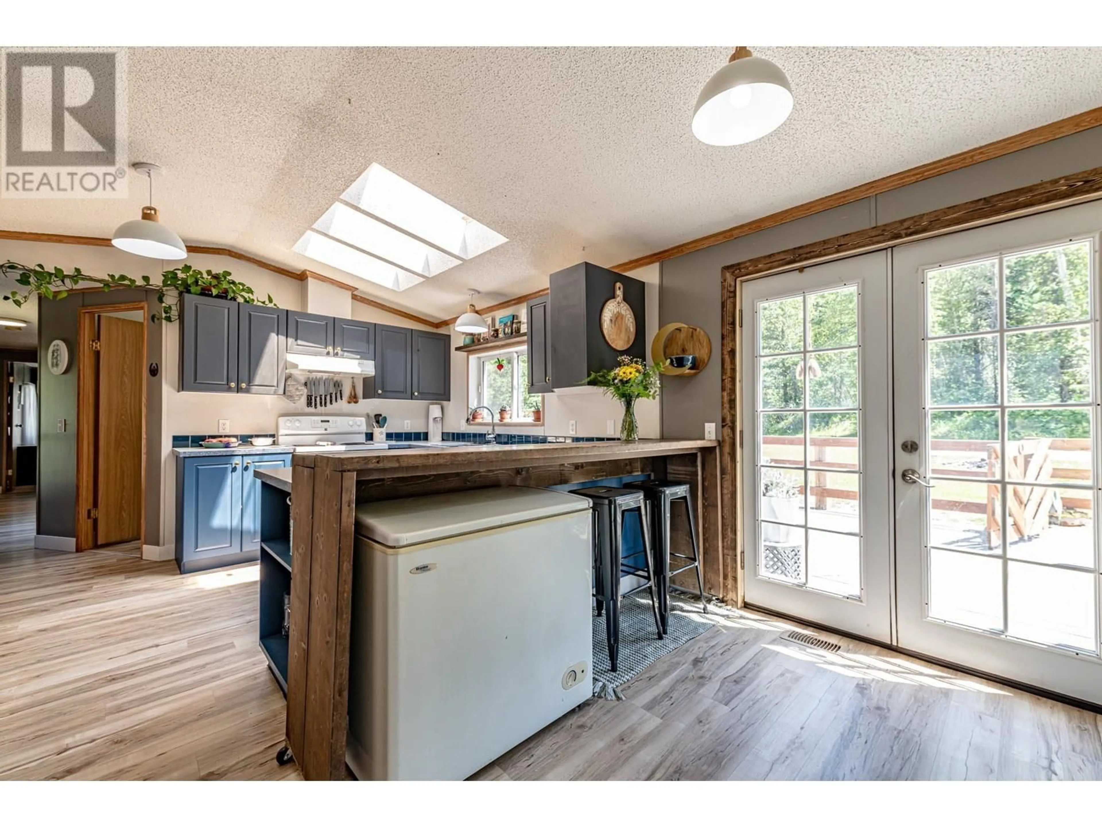 Open concept kitchen, wood/laminate floor for 1905 AIRPORT ROAD, Salmo British Columbia V0G1Z0