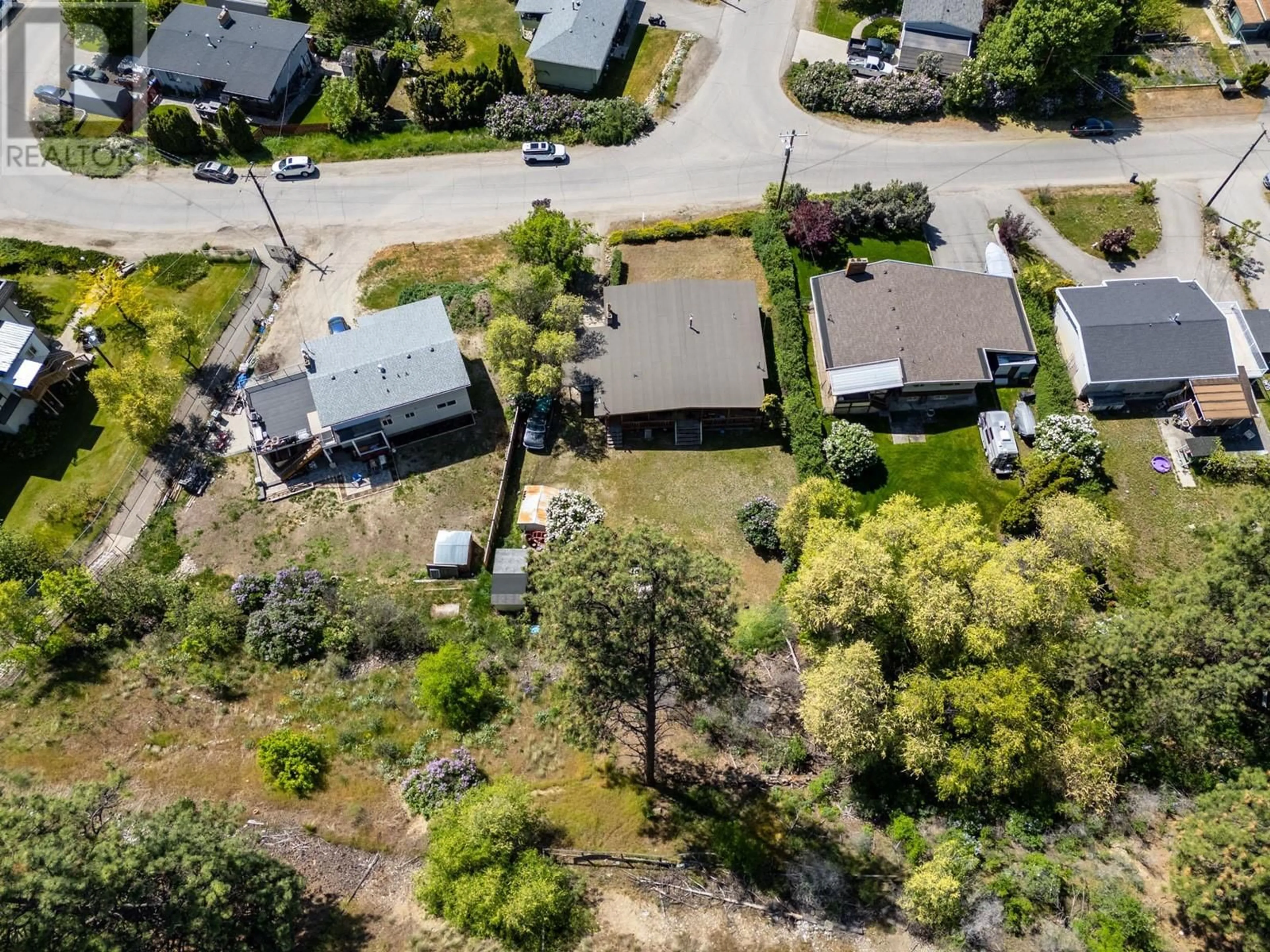 A pic from outside/outdoor area/front of a property/back of a property/a pic from drone, street for 605 DELL ROAD, Kelowna British Columbia V1X3P7