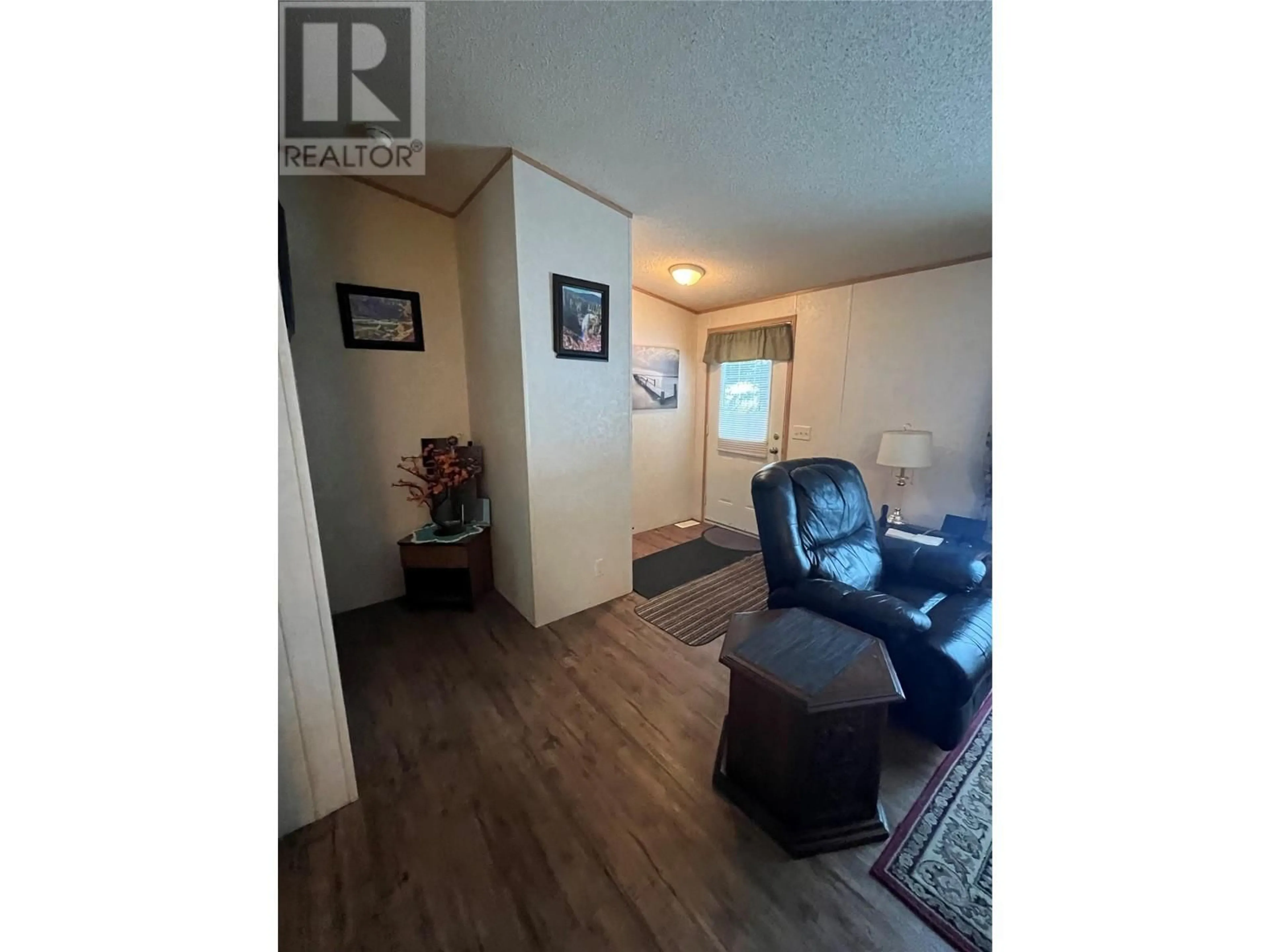 Living room with furniture, wood/laminate floor for 16 PINEWOOD PLACE, Tumbler Ridge British Columbia V0C2W0