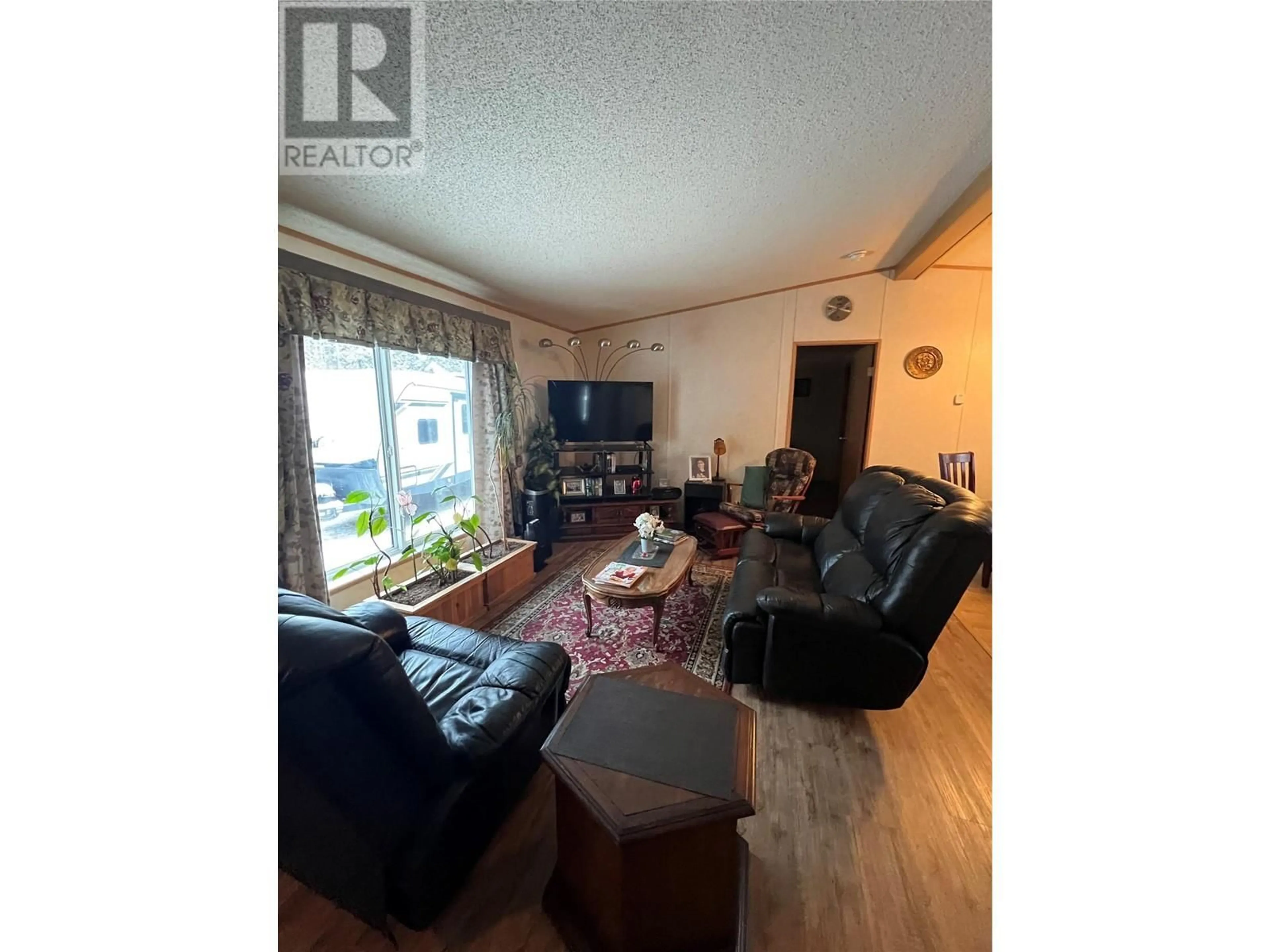 Living room with furniture, wood/laminate floor for 16 PINEWOOD PLACE, Tumbler Ridge British Columbia V0C2W0