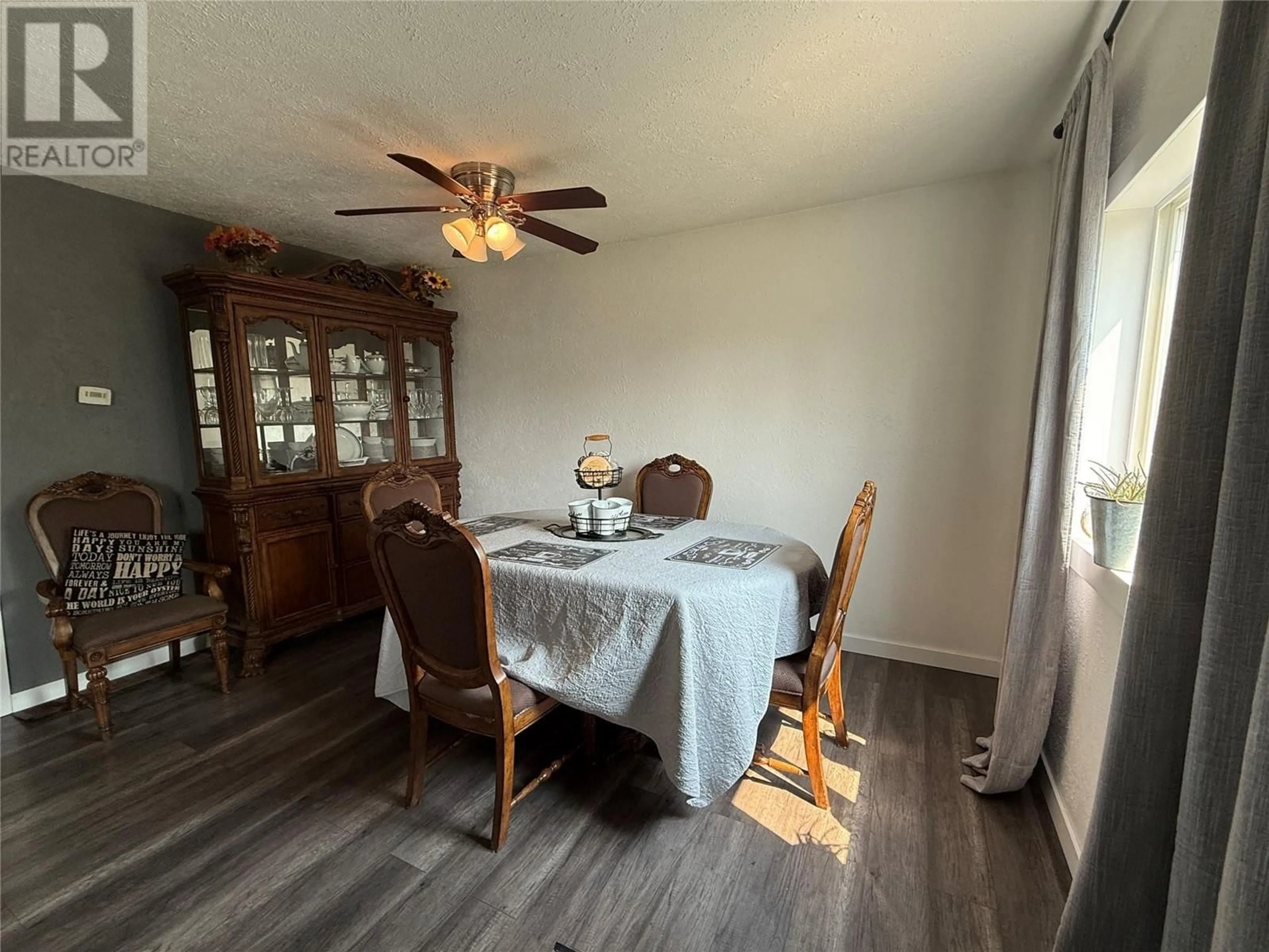Dining room, wood/laminate floor for 1408 101 AVENUE, Dawson Creek British Columbia V1G2A5