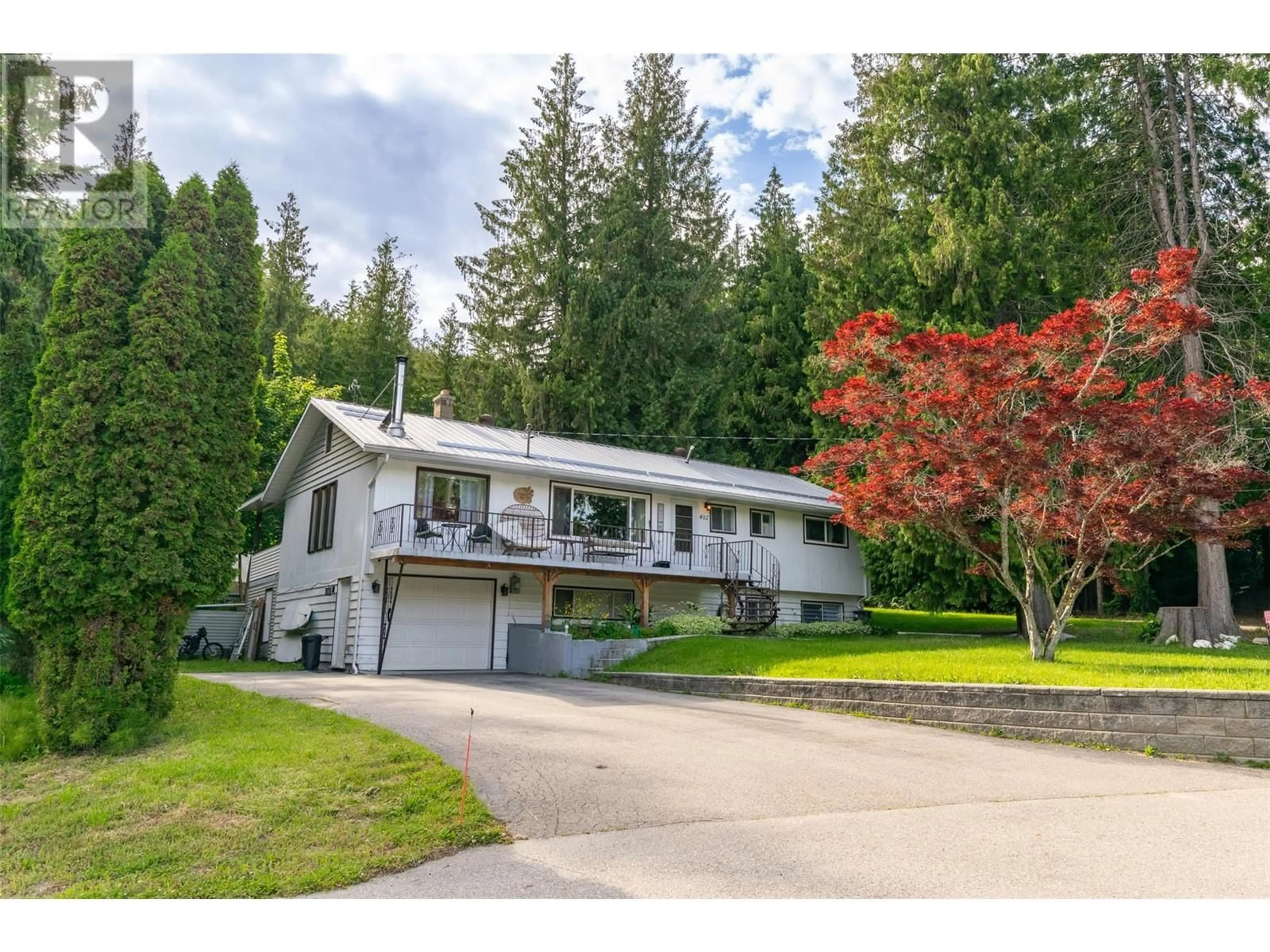 A pic from outside/outdoor area/front of a property/back of a property/a pic from drone, street for 402 COACH ROAD, Sicamous British Columbia V0E2V2