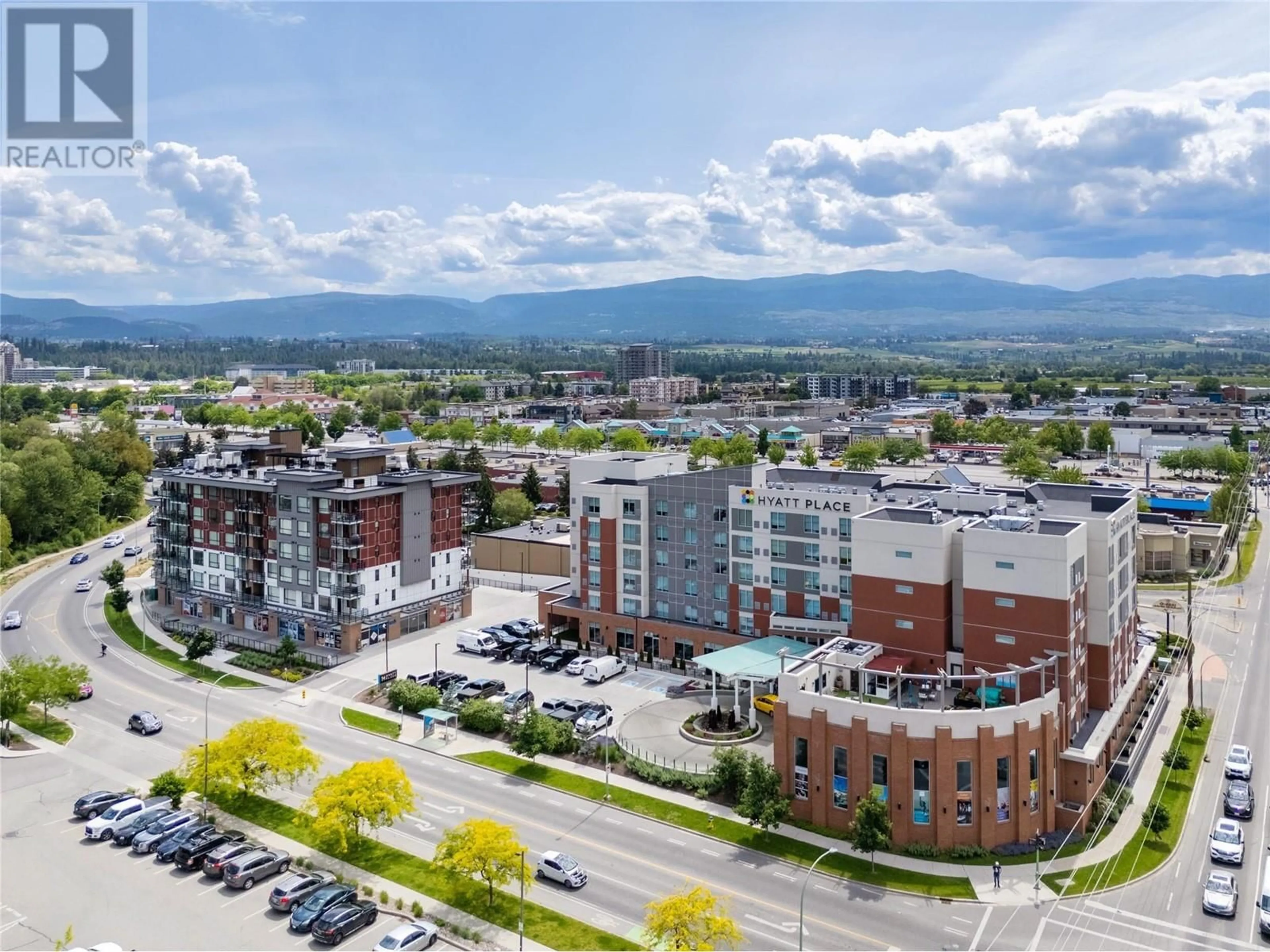 A pic from outside/outdoor area/front of a property/back of a property/a pic from drone, mountain view for 304 - 1925 ENTERPRISE WAY, Kelowna British Columbia V1Y0J8