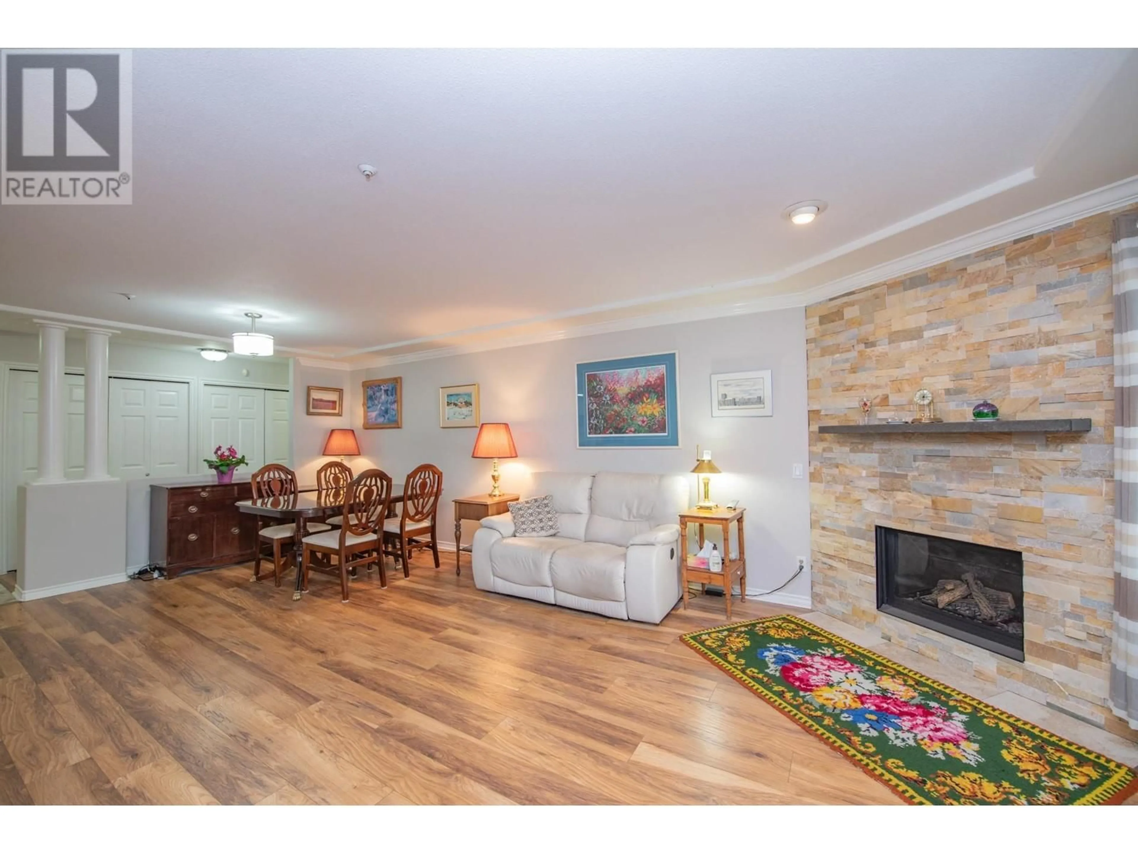 Living room with furniture, wood/laminate floor for 102 - 3300 CENTENNIAL DRIVE, Vernon British Columbia V1T9M5