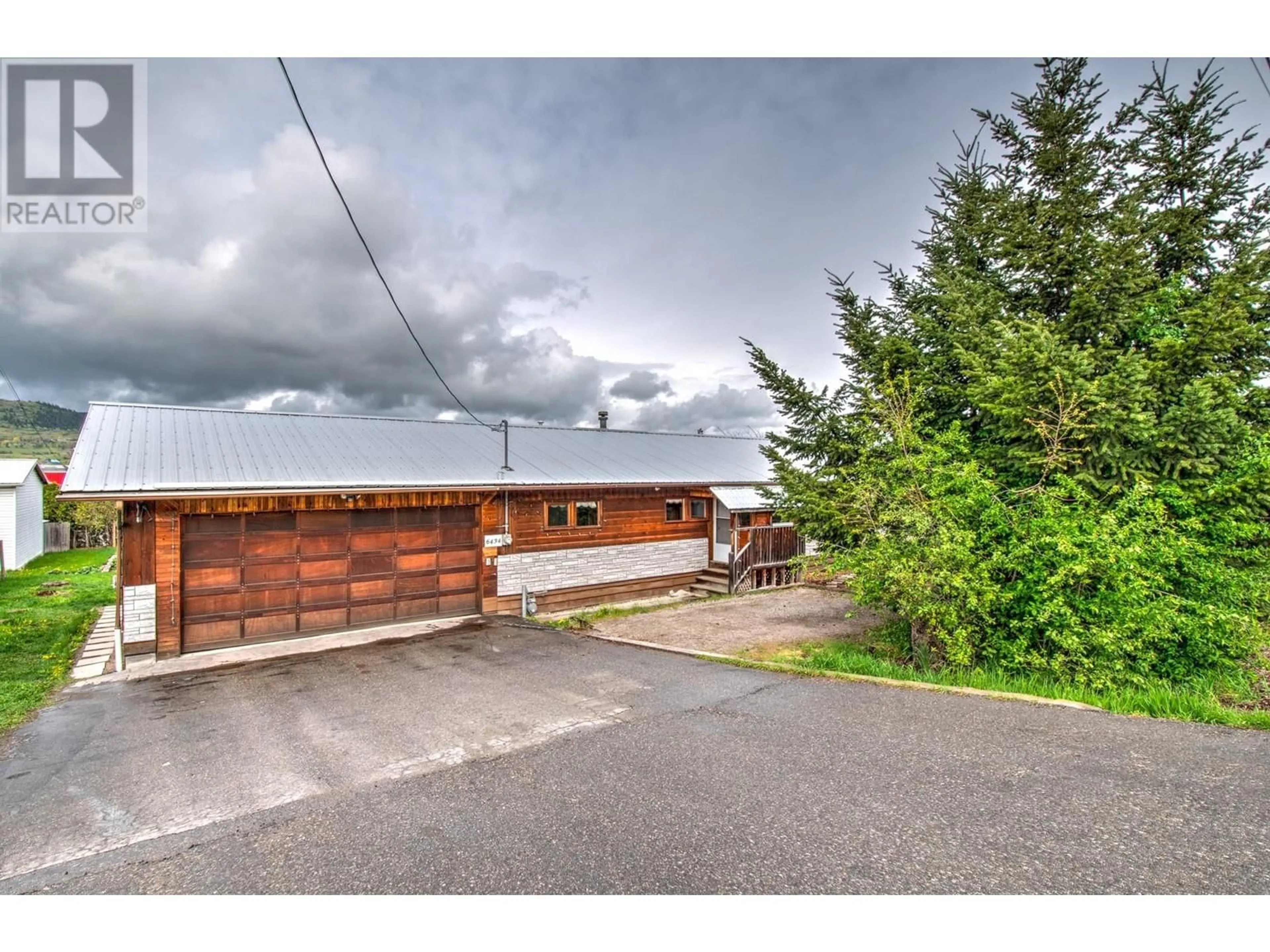 A pic from outside/outdoor area/front of a property/back of a property/a pic from drone, street for 6434 PLEASANT VALLEY ROAD, Vernon British Columbia V1B3R3