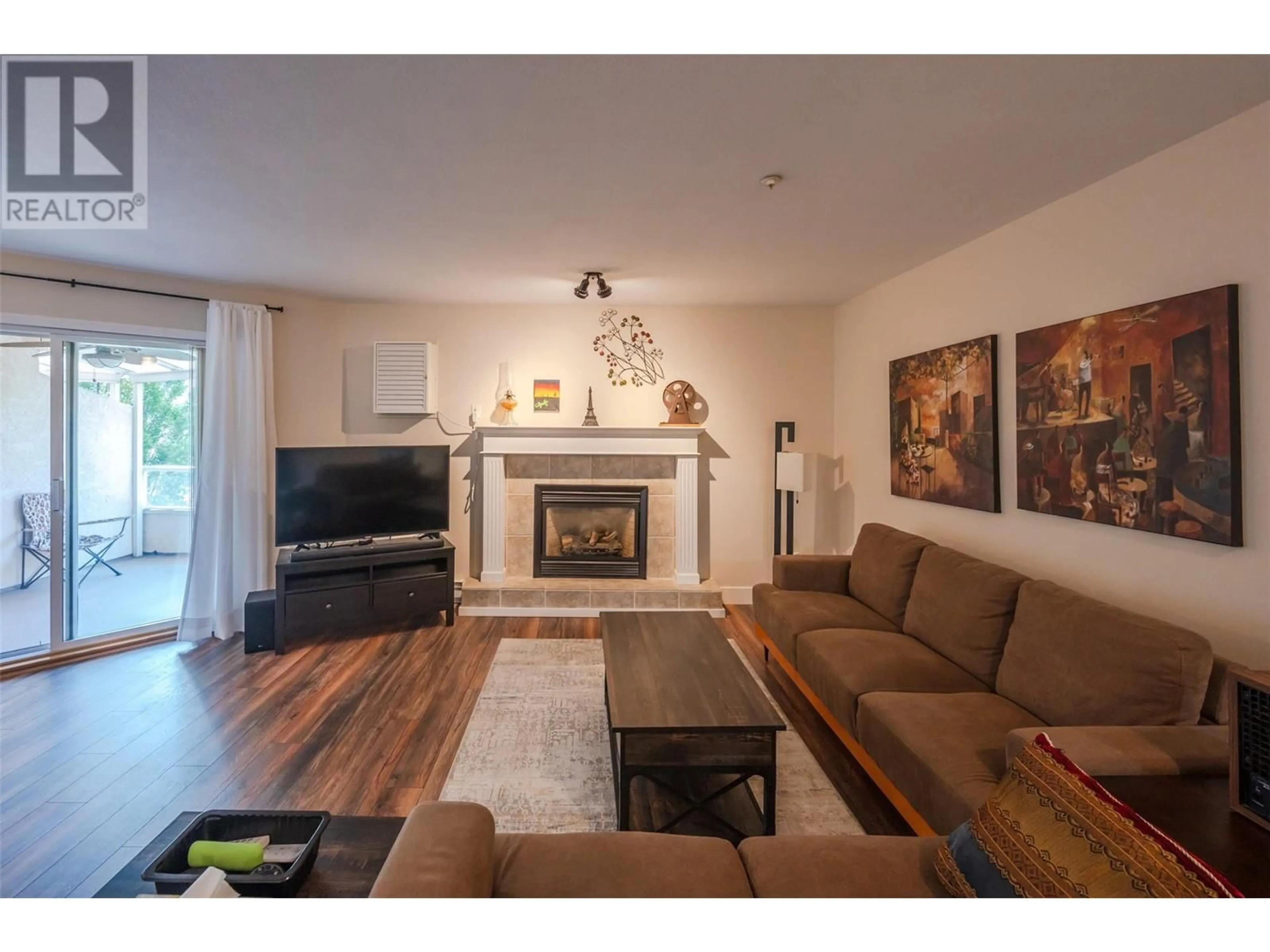 Living room with furniture, wood/laminate floor for 408 - 1750 ATKINSON STREET, Penticton British Columbia V2A7M6