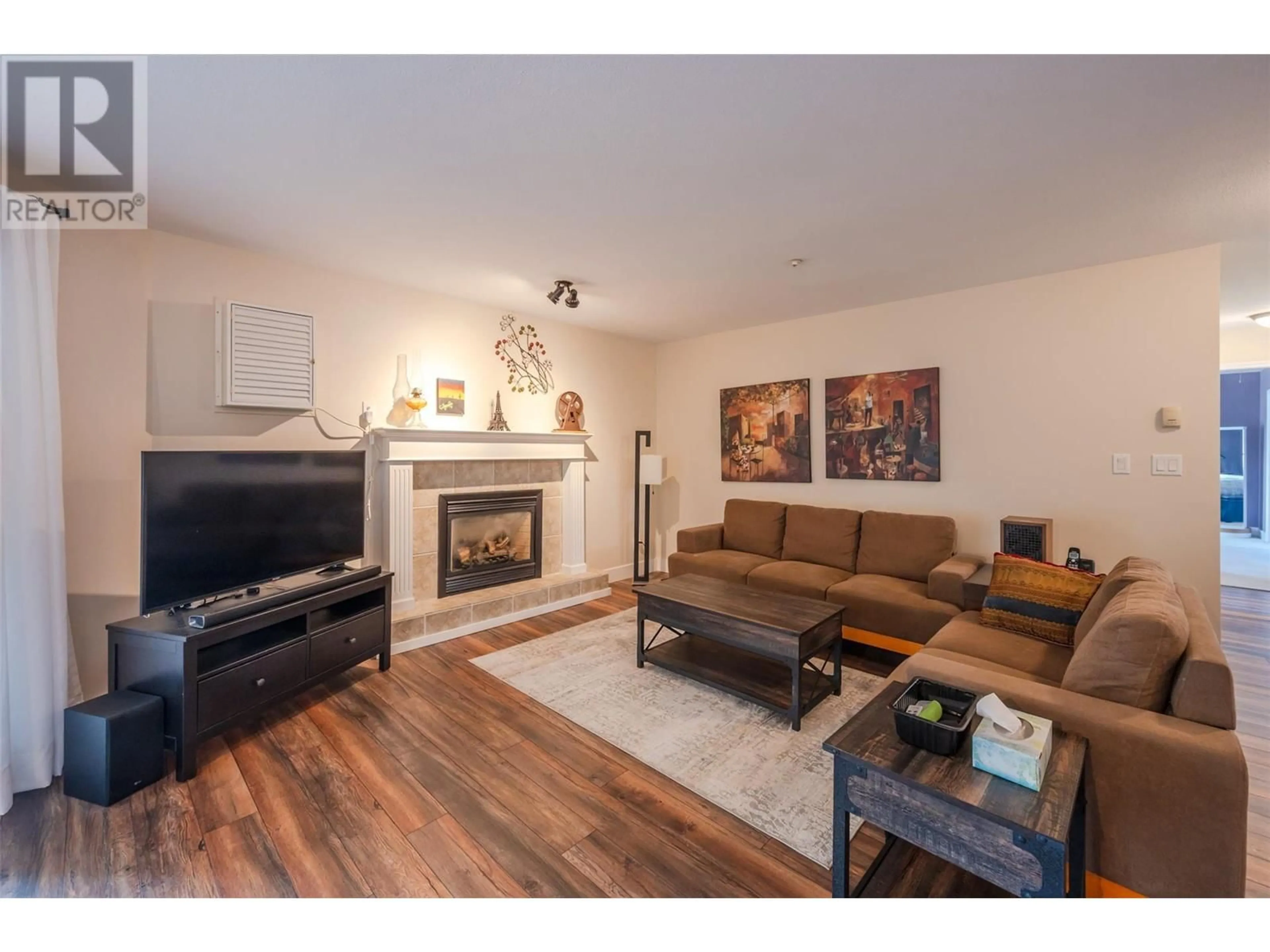 Living room with furniture, wood/laminate floor for 408 - 1750 ATKINSON STREET, Penticton British Columbia V2A7M6