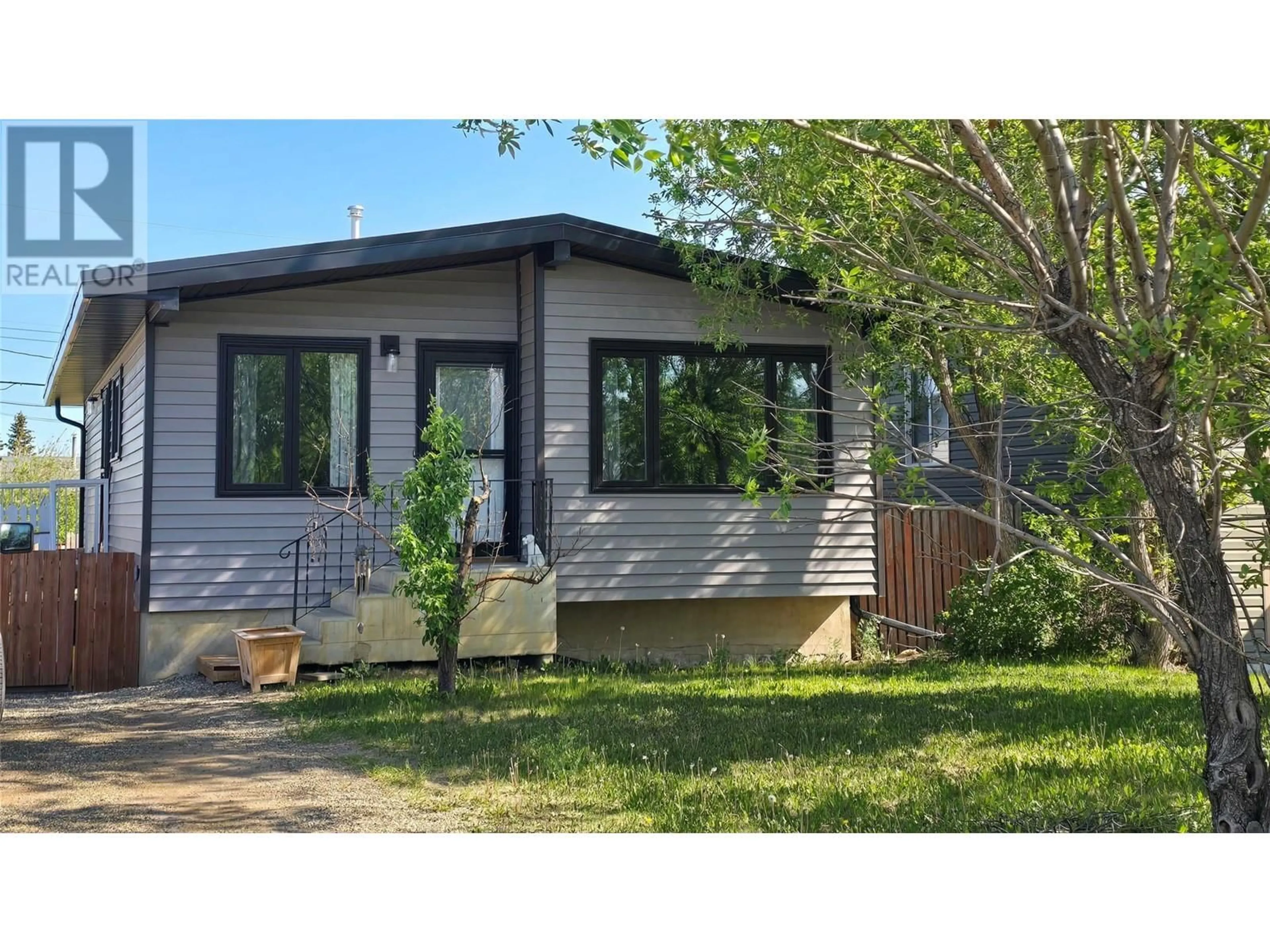 Home with vinyl exterior material, street for 1036 121 AVENUE, Dawson Creek British Columbia V1G3K4