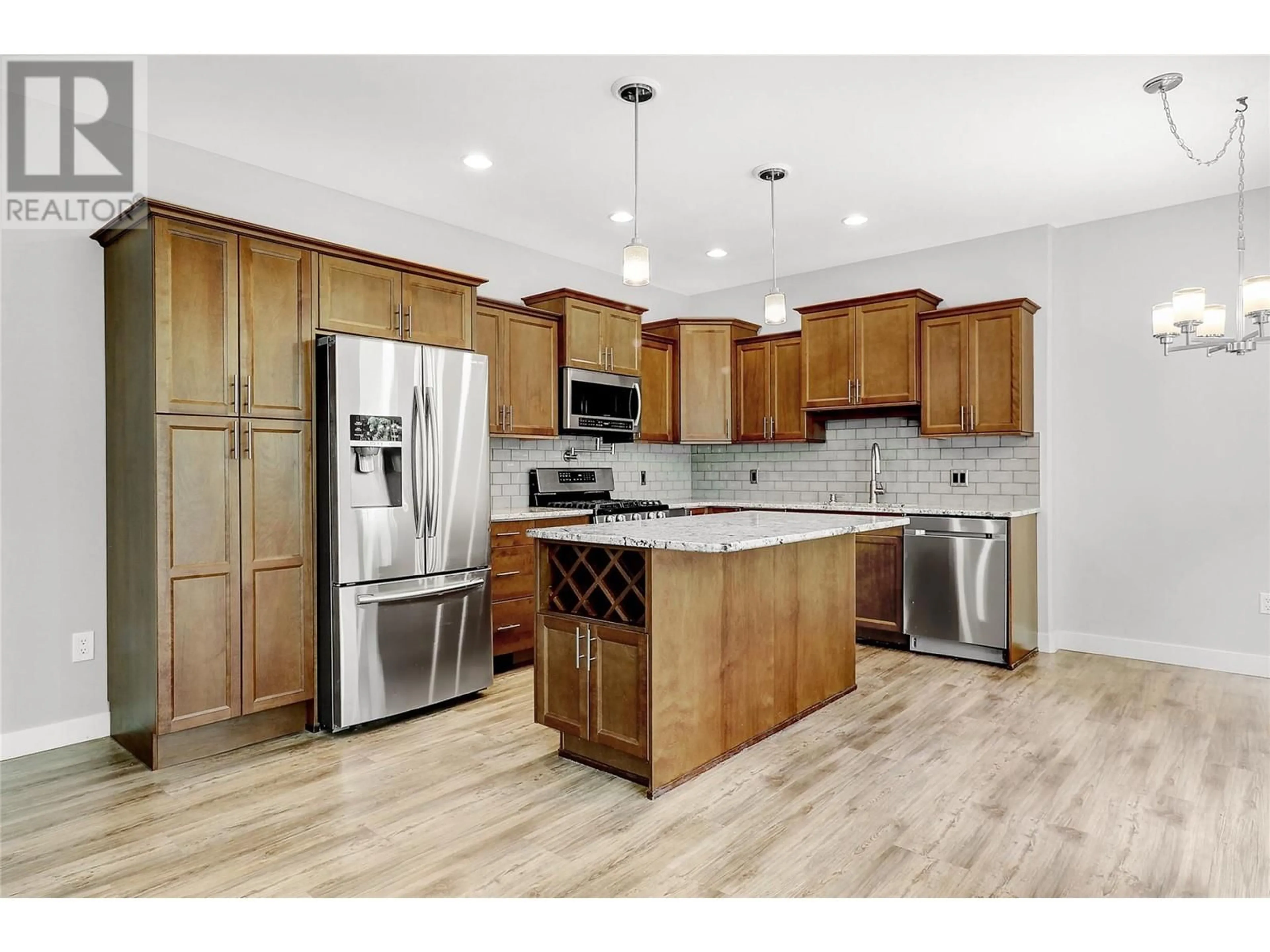 Open concept kitchen, wood/laminate floor for 503 - 3350 WOODSDALE ROAD, Lake Country British Columbia V4V2R7