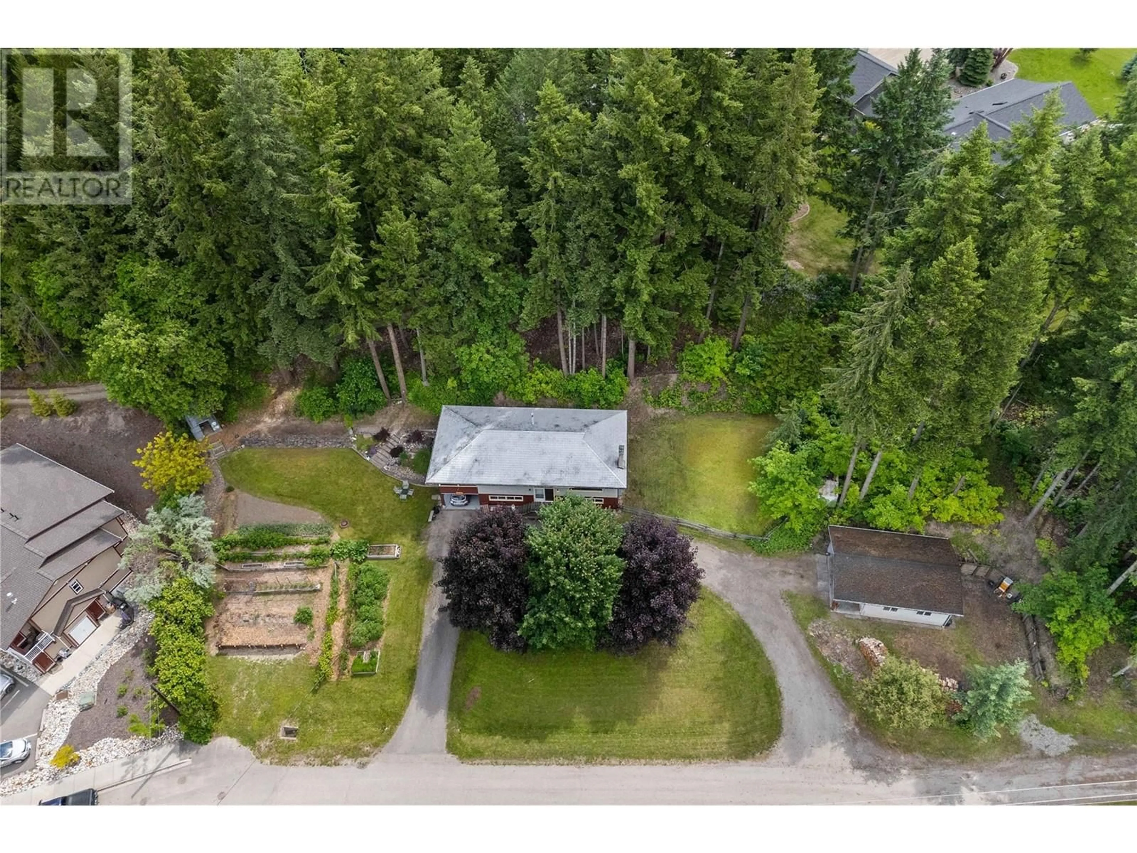 A pic from outside/outdoor area/front of a property/back of a property/a pic from drone, forest/trees view for 1230 1 STREET SOUTHEAST, Salmon Arm British Columbia V1E1J3